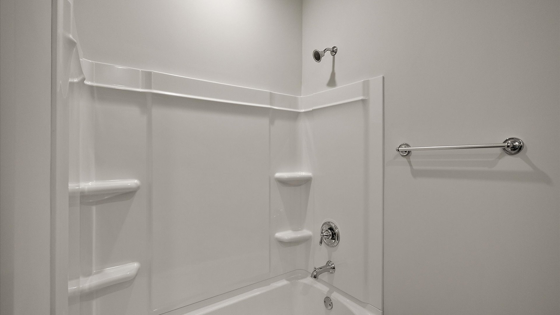 Shower tub combination with built-in shelving.