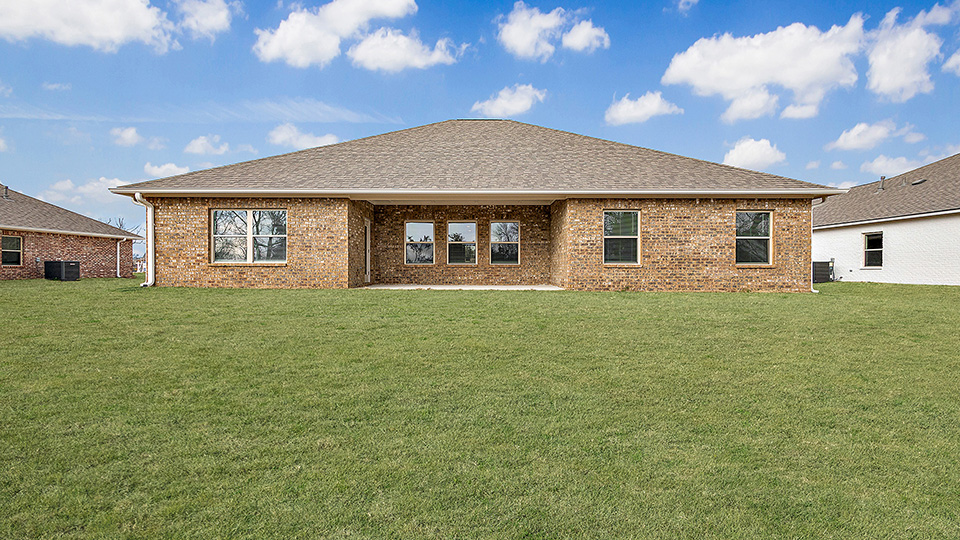 The covered patio opens to greenspace.