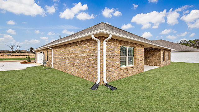 The covered patio opens to greenspace.
