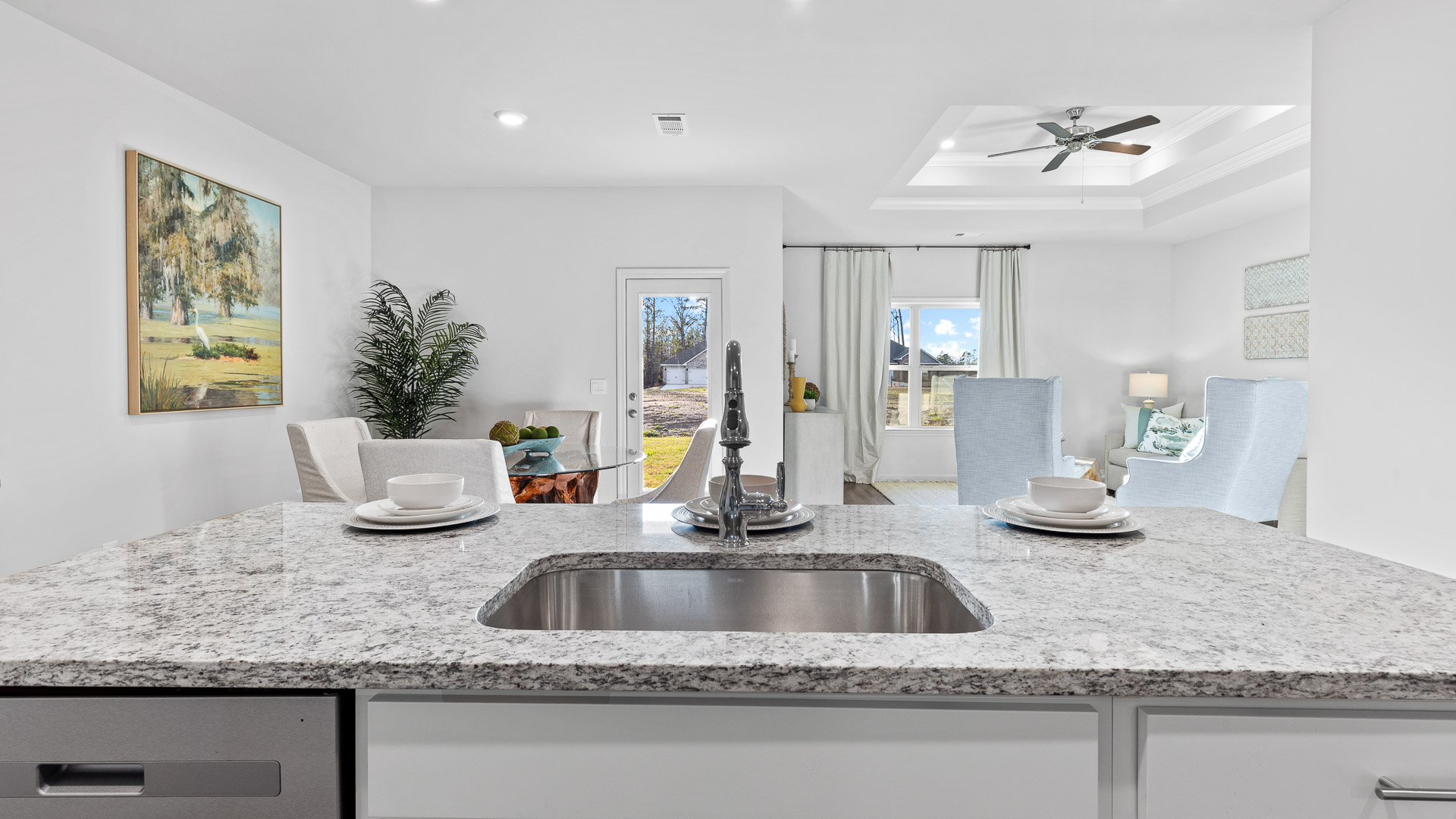 spacious kitchen featuring white cabinetry, large island, and stainless steel appliances