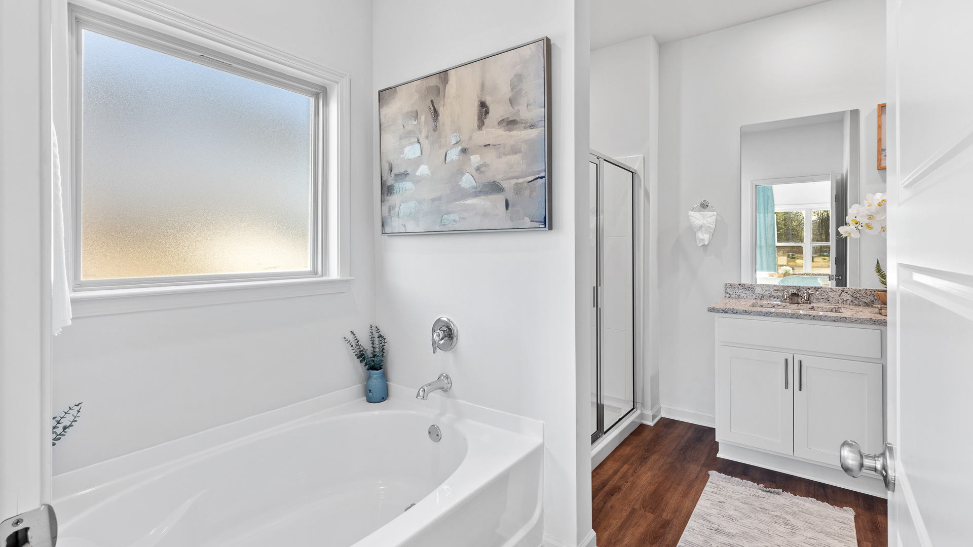 bathroom featuring a separate bathtub, and dual vanity sinks