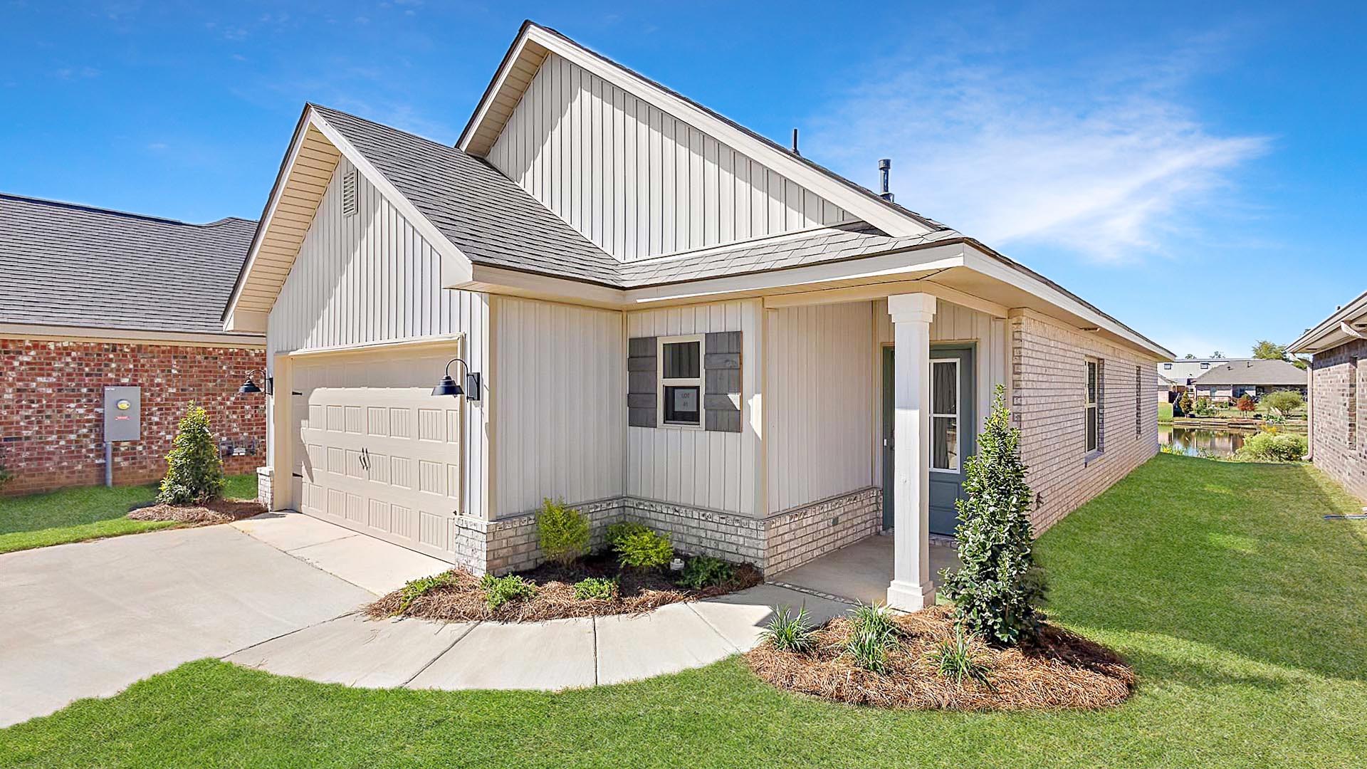 Allex one-story exterior home front view with brown brick, a window, and a two-car garage.