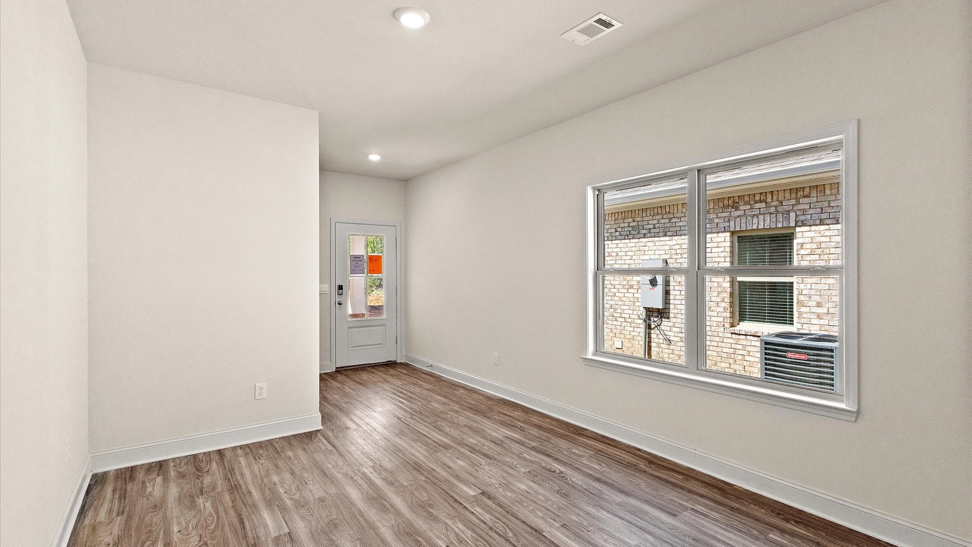 Living area adjacent to the entryway with a double window.