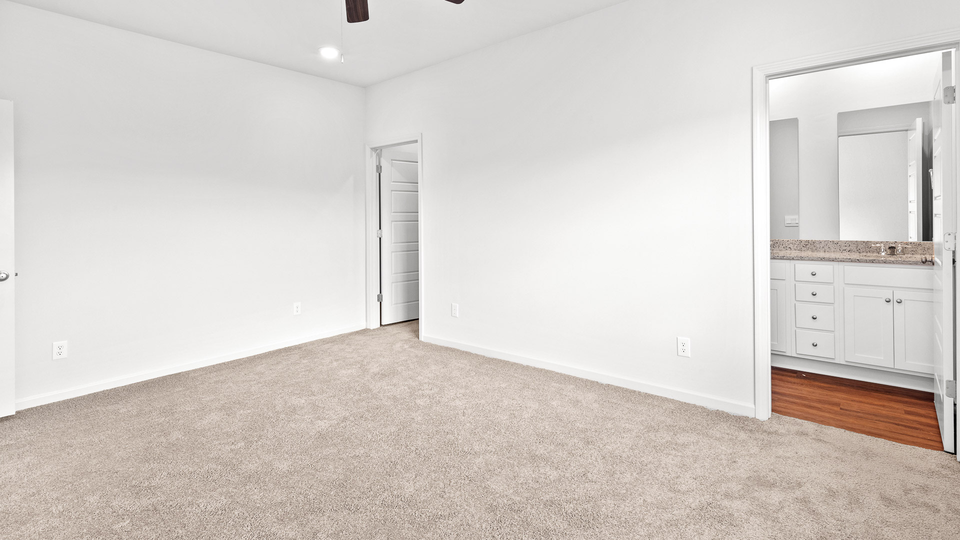 primary bedroom with carpeted floors