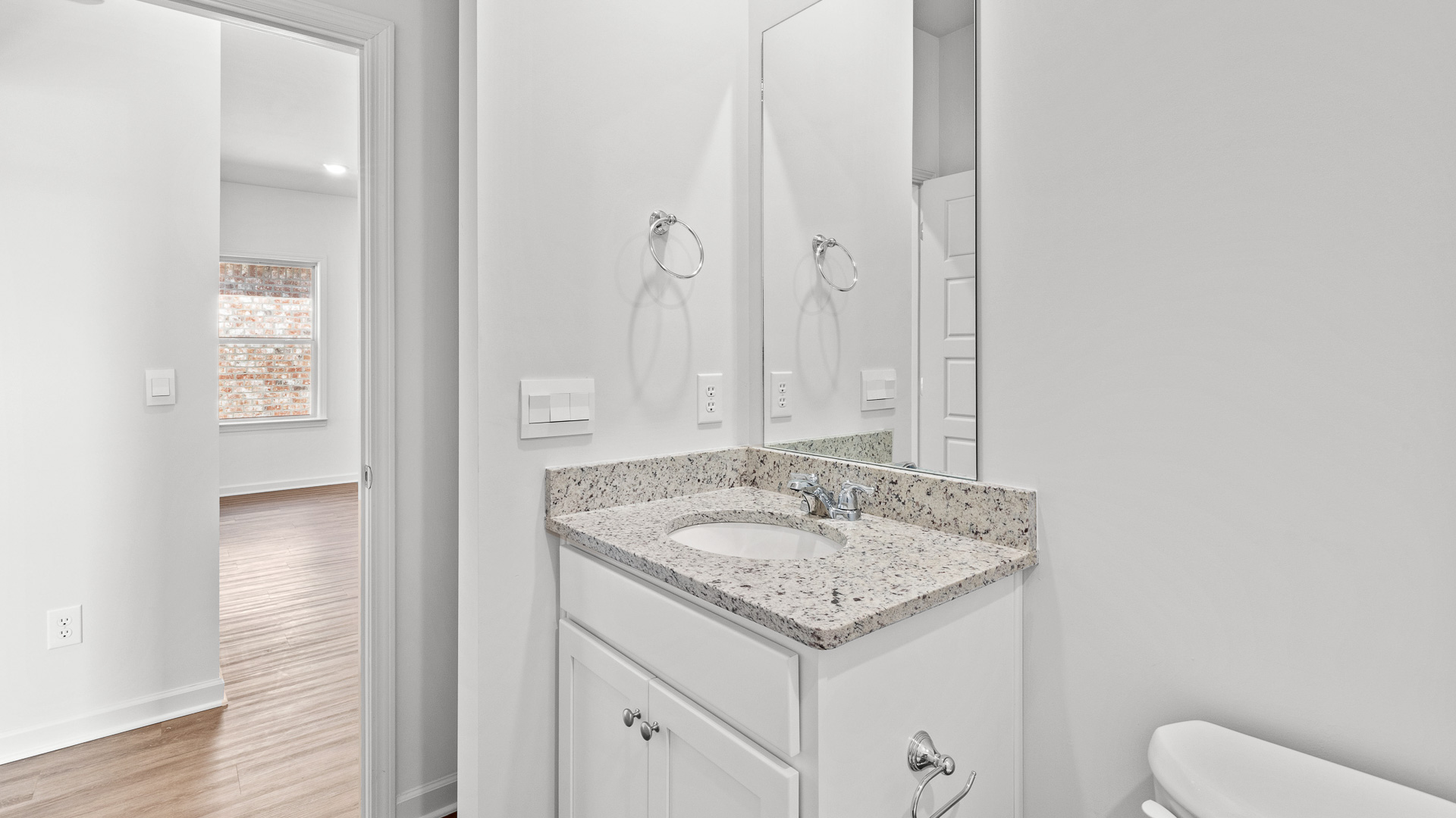 bathroom featuring a vanity sink, toilet, bathtub and built in shelves