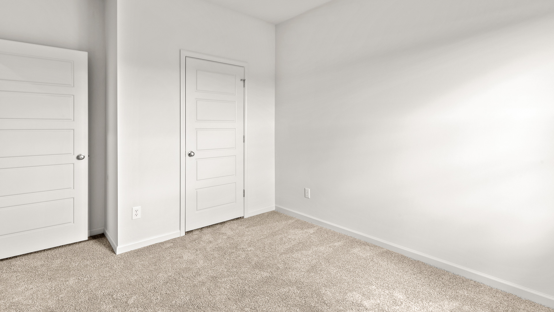 bedroom featuring beige carpet, white walls and a closet