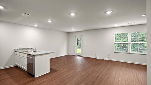Open concept space of the kitchen, dining, and living area.