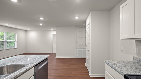 Back side of kitchen area with view of the open concept house.