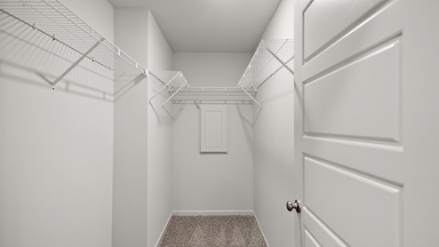 Large walk in closet with shelving.