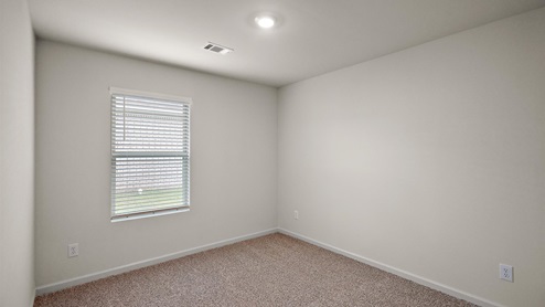 Other side of bedroom with single window.