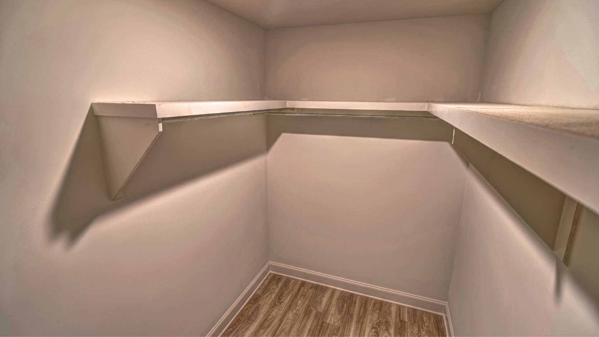 interior walk in closet with some built in shelving
