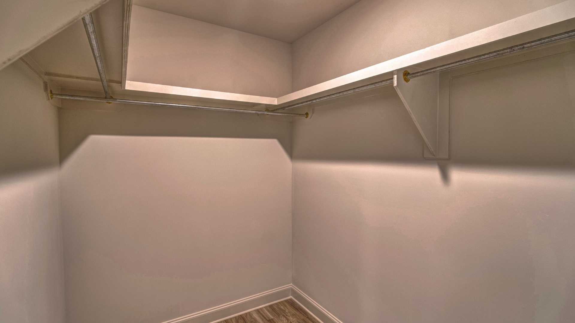 interior walk in closet with some built in shelving