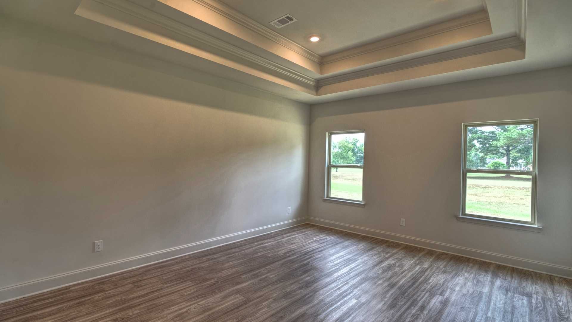 interior bedroom with coffered ceilings and multiple windows