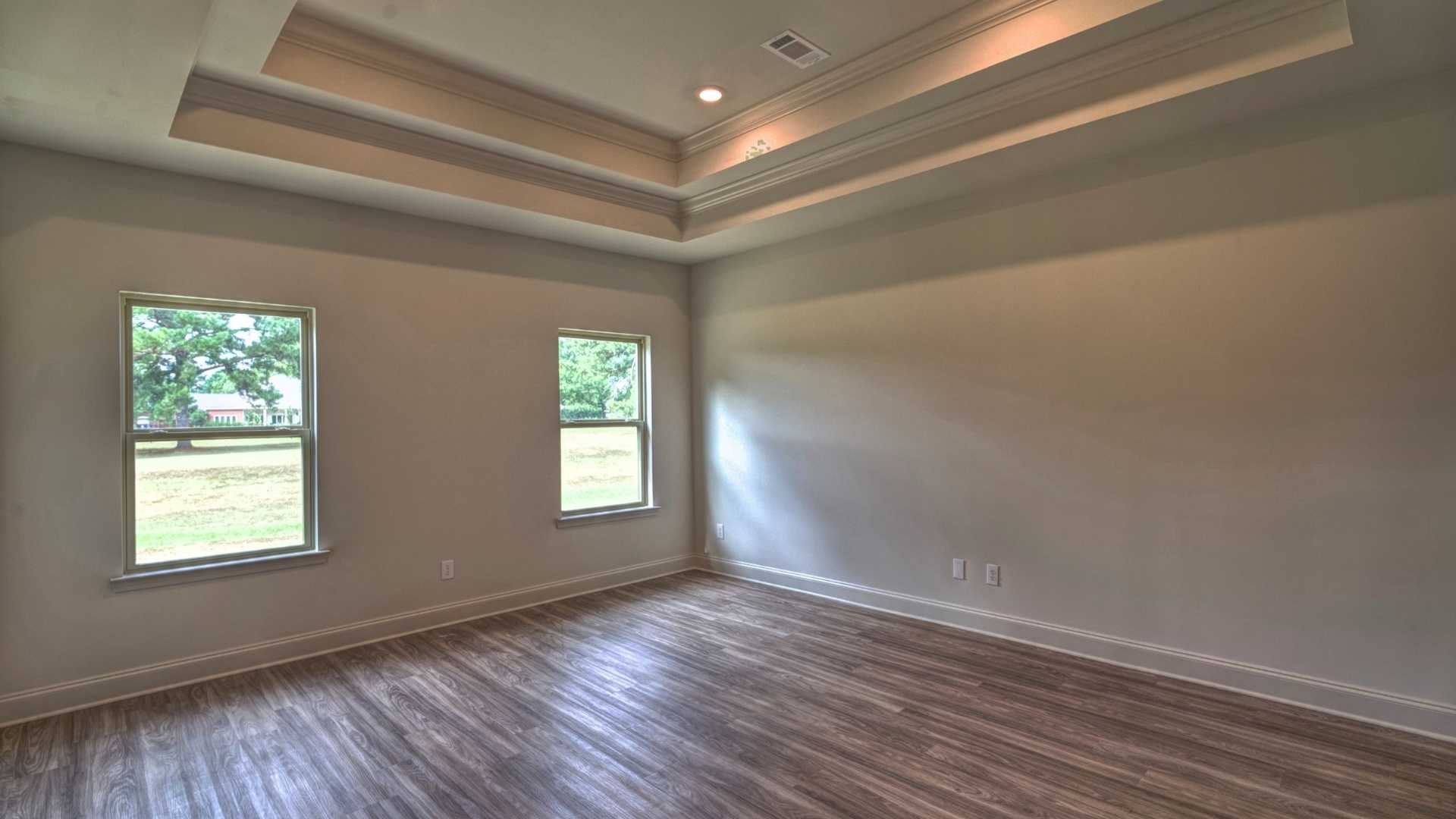 interior bedroom with coffered ceilings and multiple windows