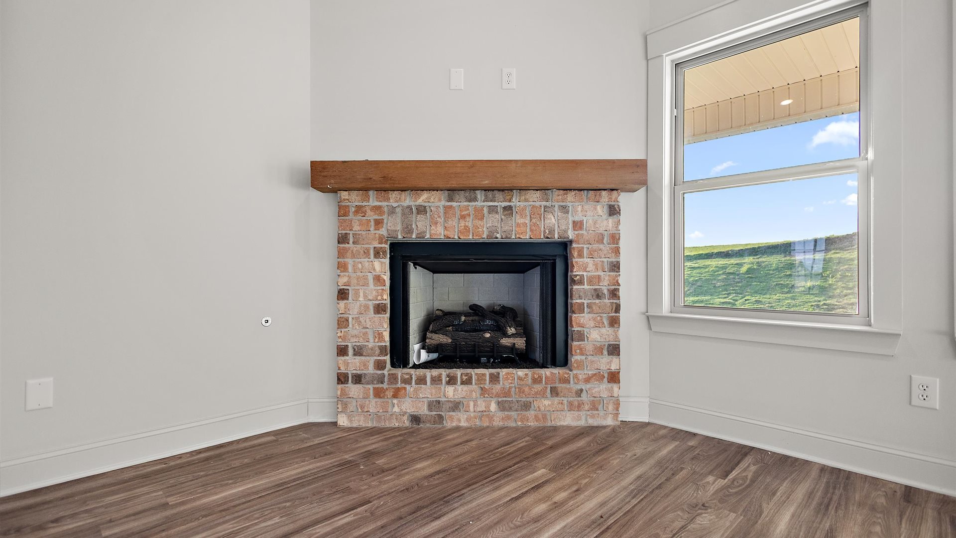 View from kitchen into the dining and living rooms, electric fire place, with outdoor access to patio at Cornerstone