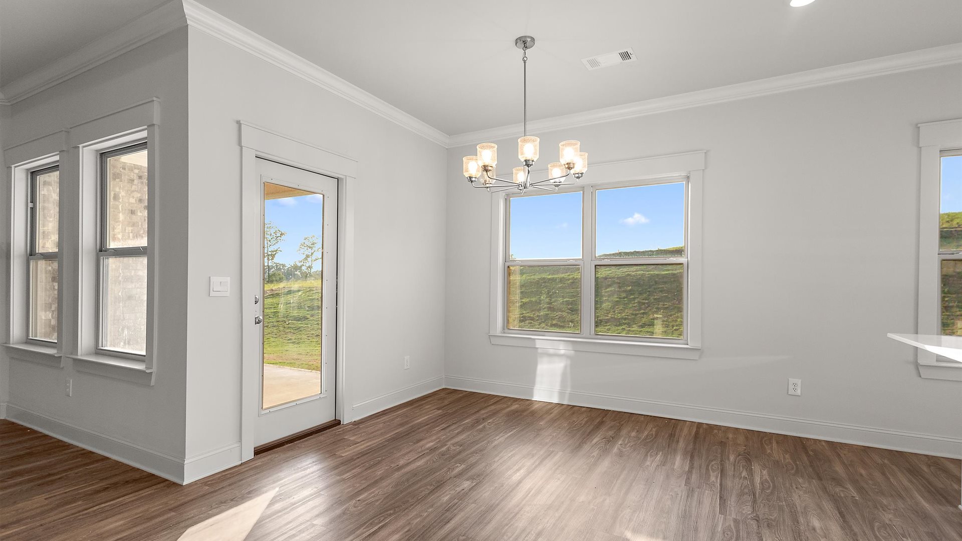 Dining room looking toward living area, and electric fire place, outside and backyard access at Cornerstone