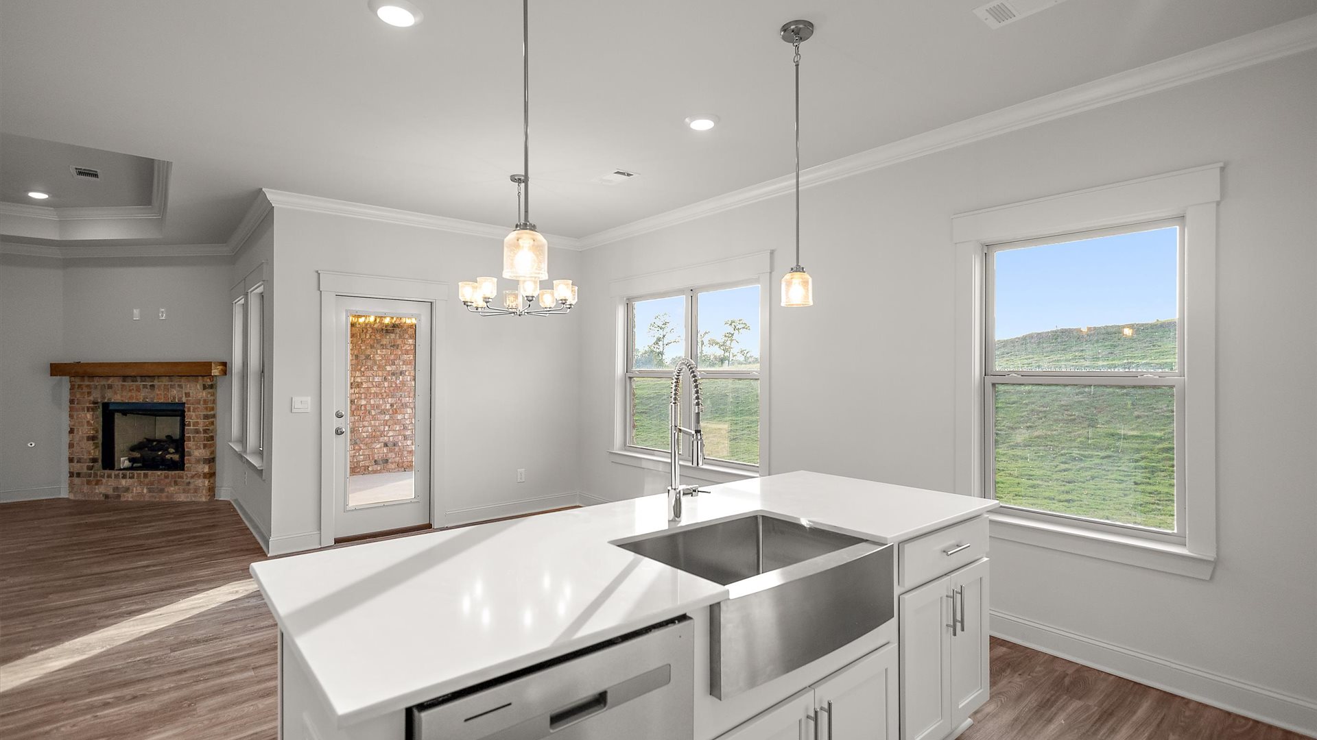 New build home features central island design, pantry, multi-prep zones, sink, dining and living rooms, outside areas