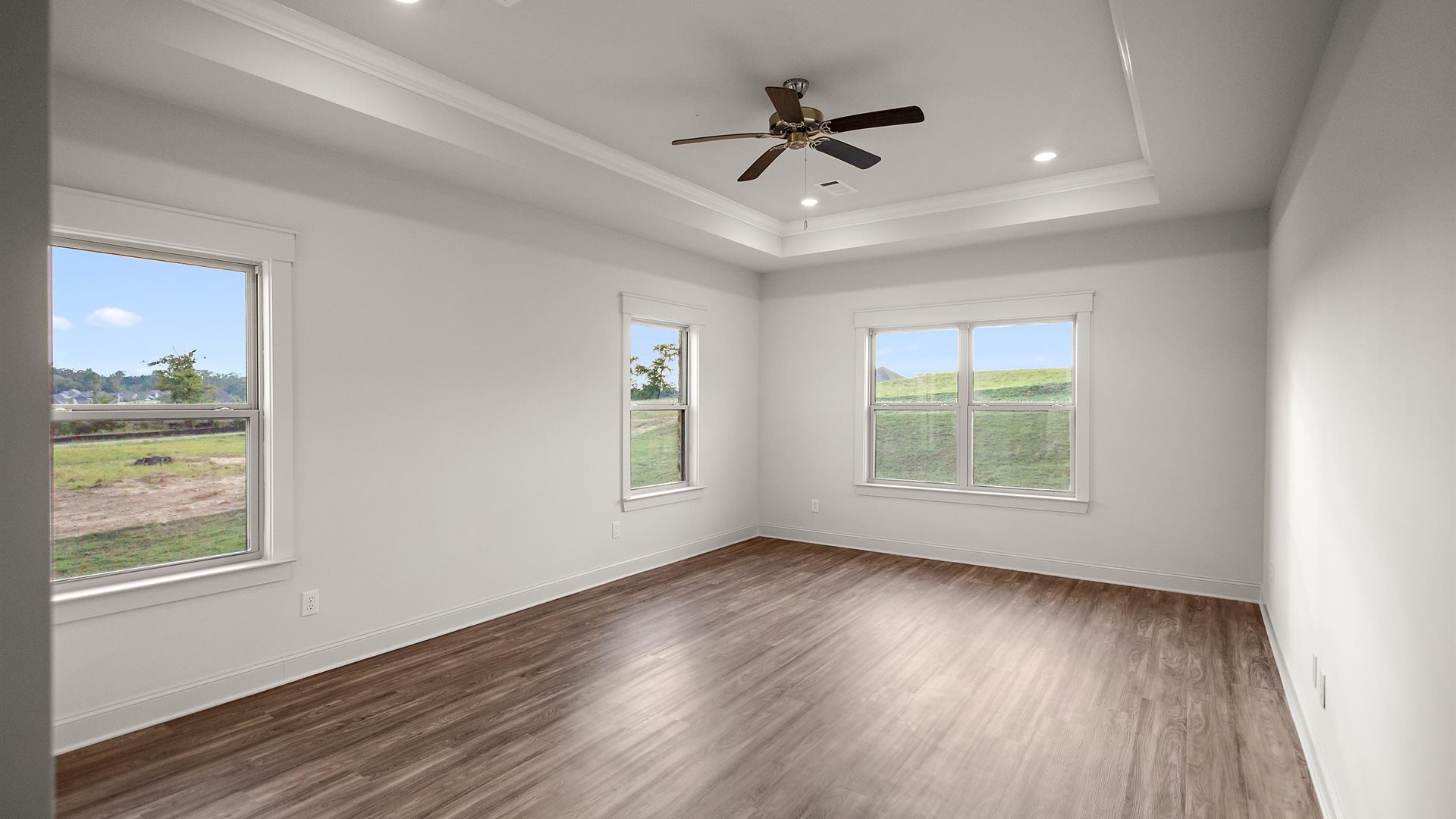 Primary bedroom features ample space, double windows, soft carpet, a stylish walk-in closet, and a private ensuite bath