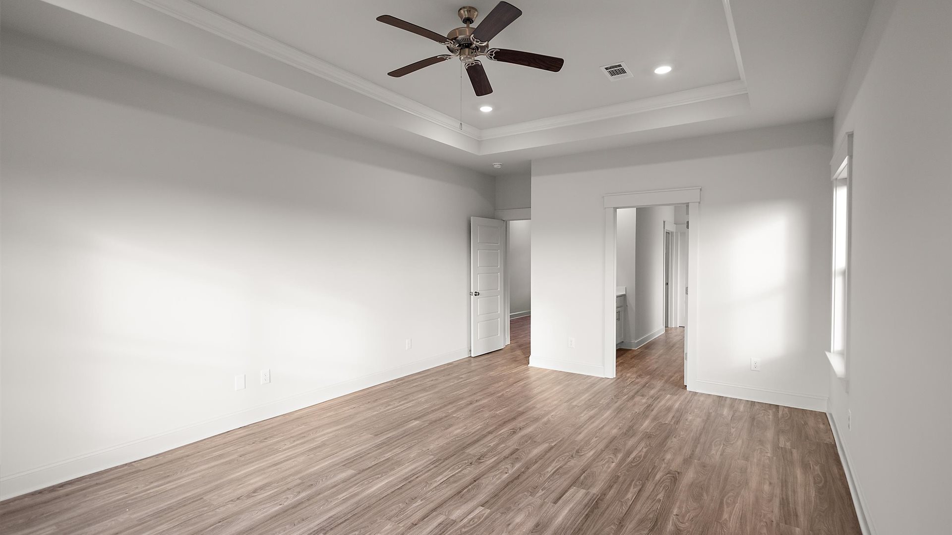 Owner’s suite offers natural window light, spa-inspired ensuite bathroom, backyard view, walk-in closet for everyday style