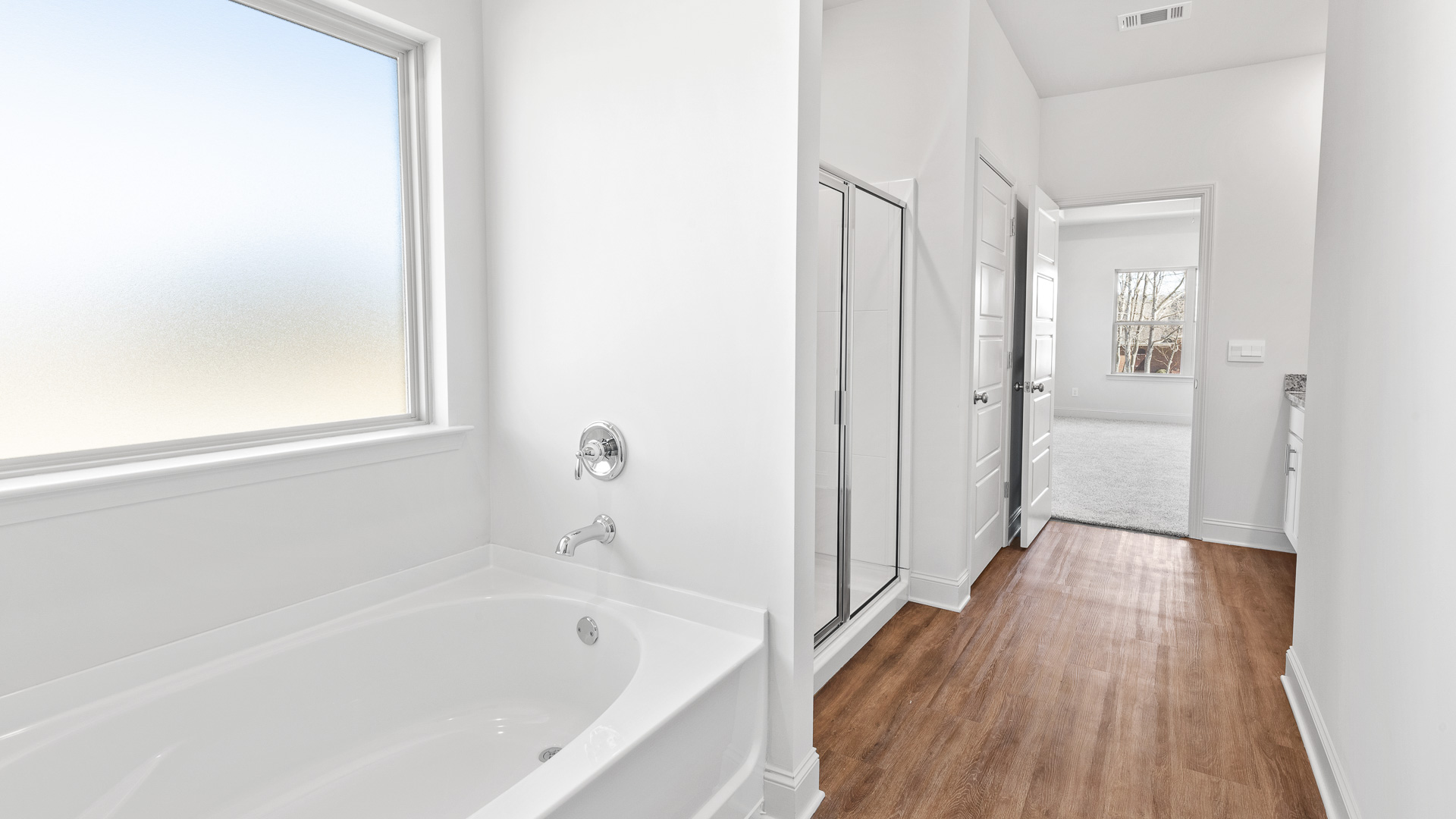 Bathtub with large frosted window.