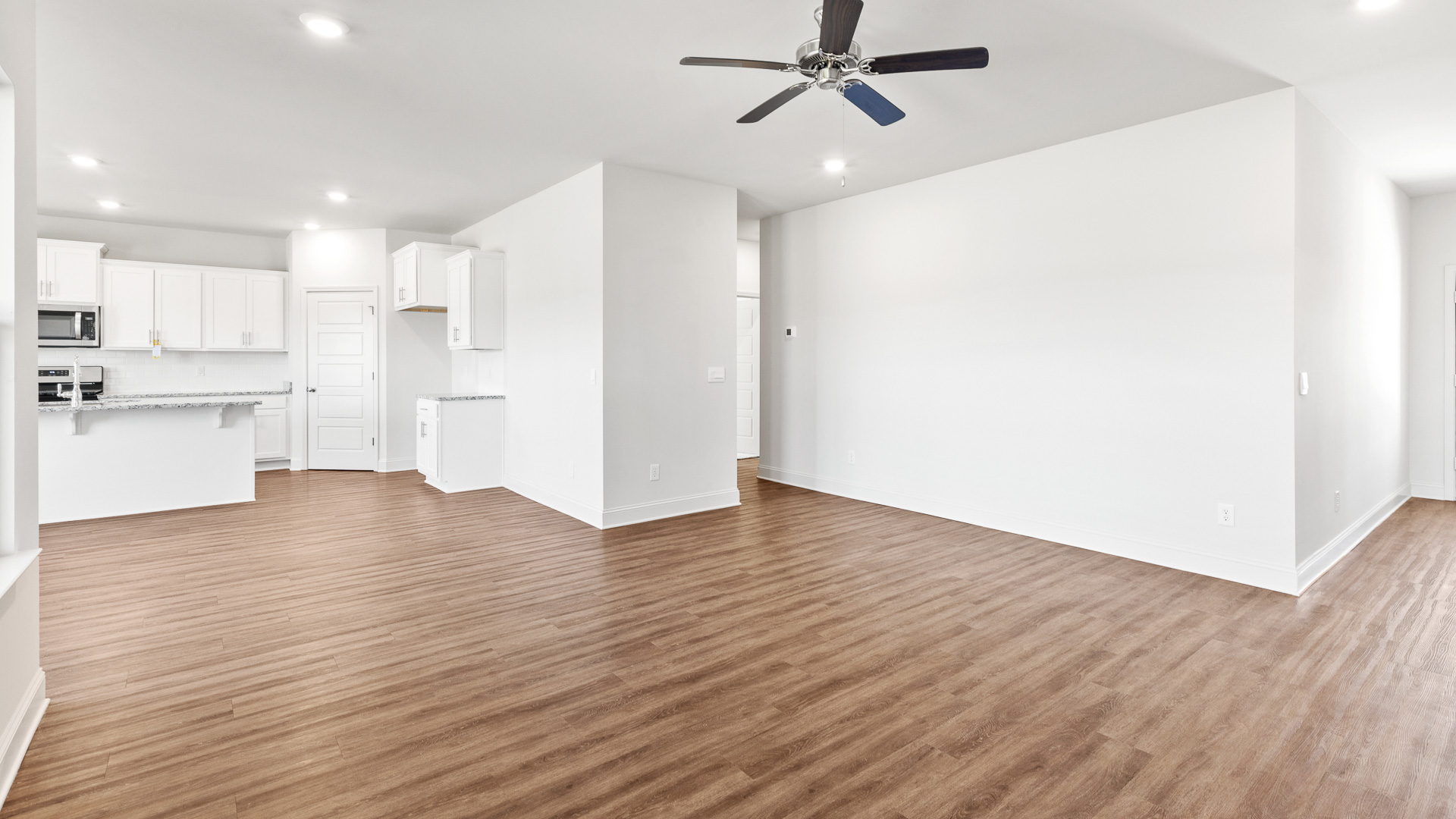 Open living room with view of kitchen.