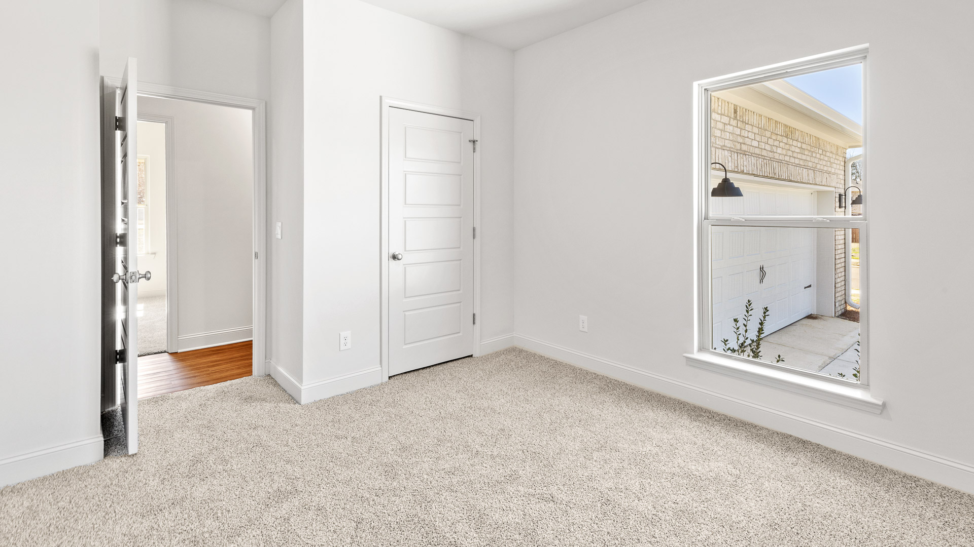 Bedroom near the front of the house with large window and closet.
