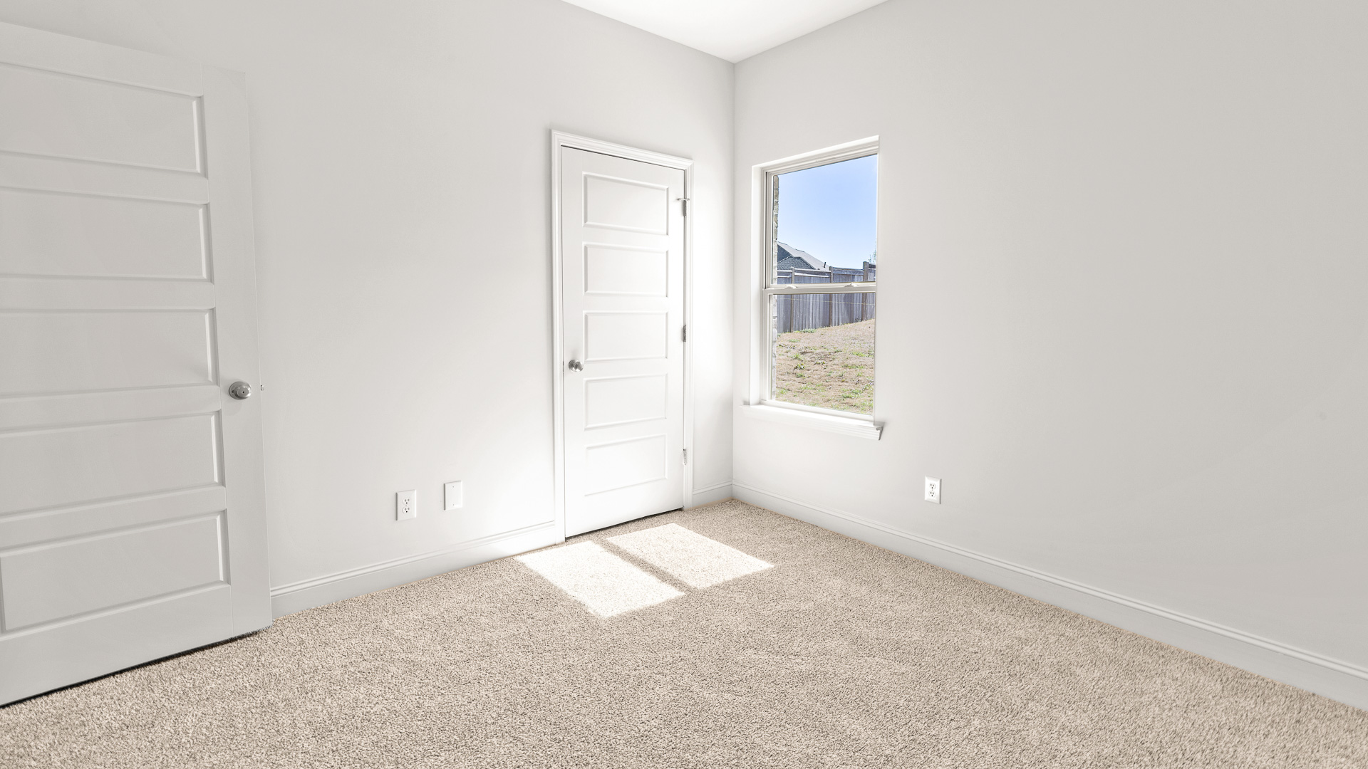 Bedroom with view of backyard and good sized closet.