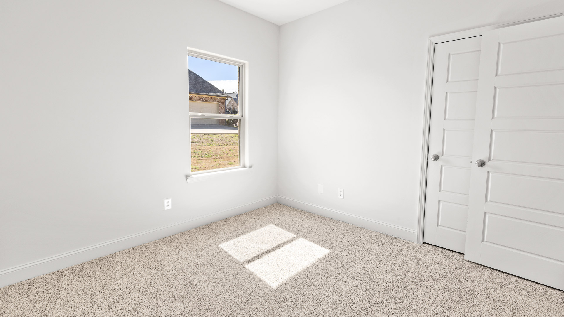 Bedroom with carpeted floors and light walls.