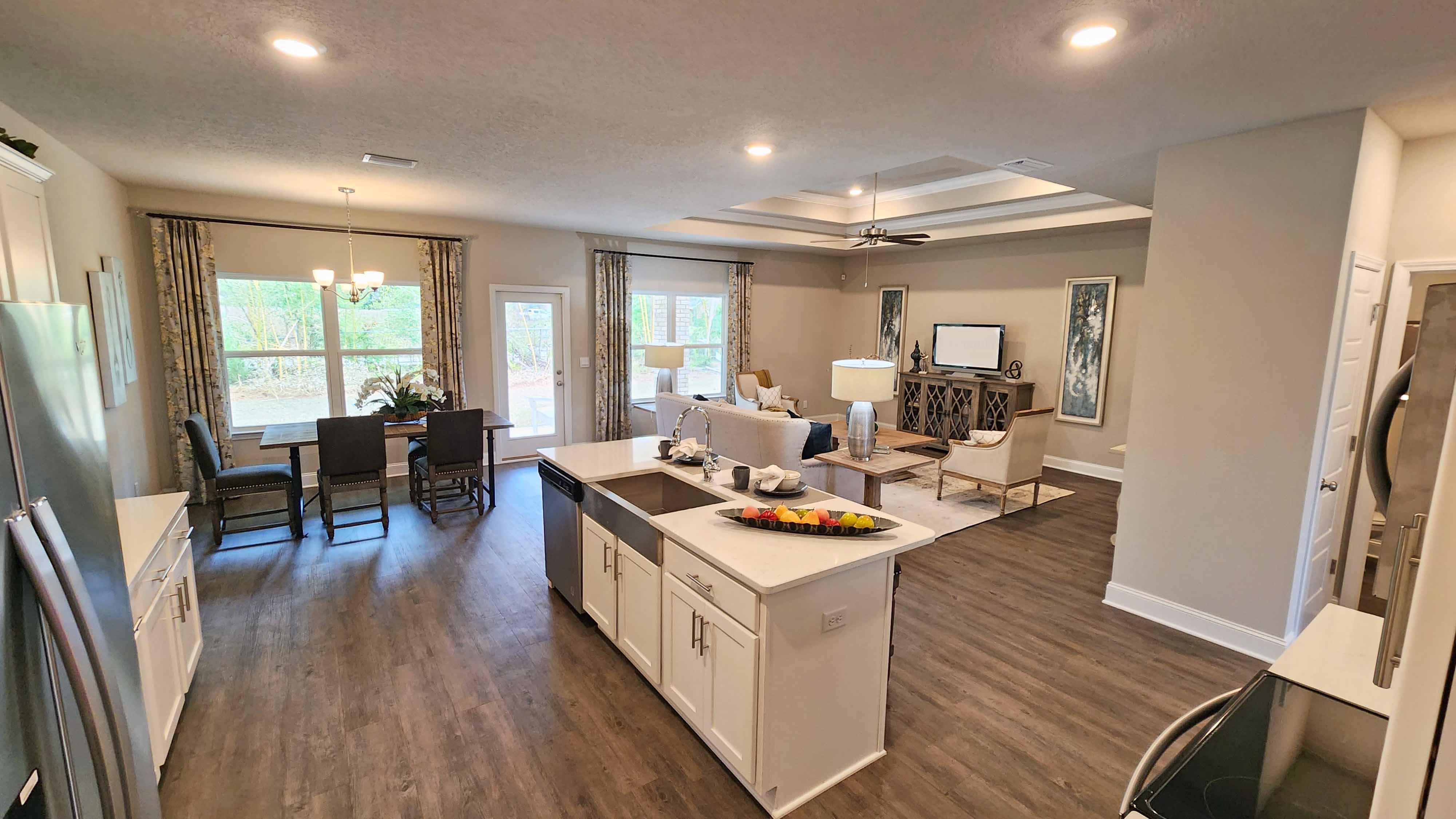 kitchen overlooking the living space with hardwood floors and recessed lighting