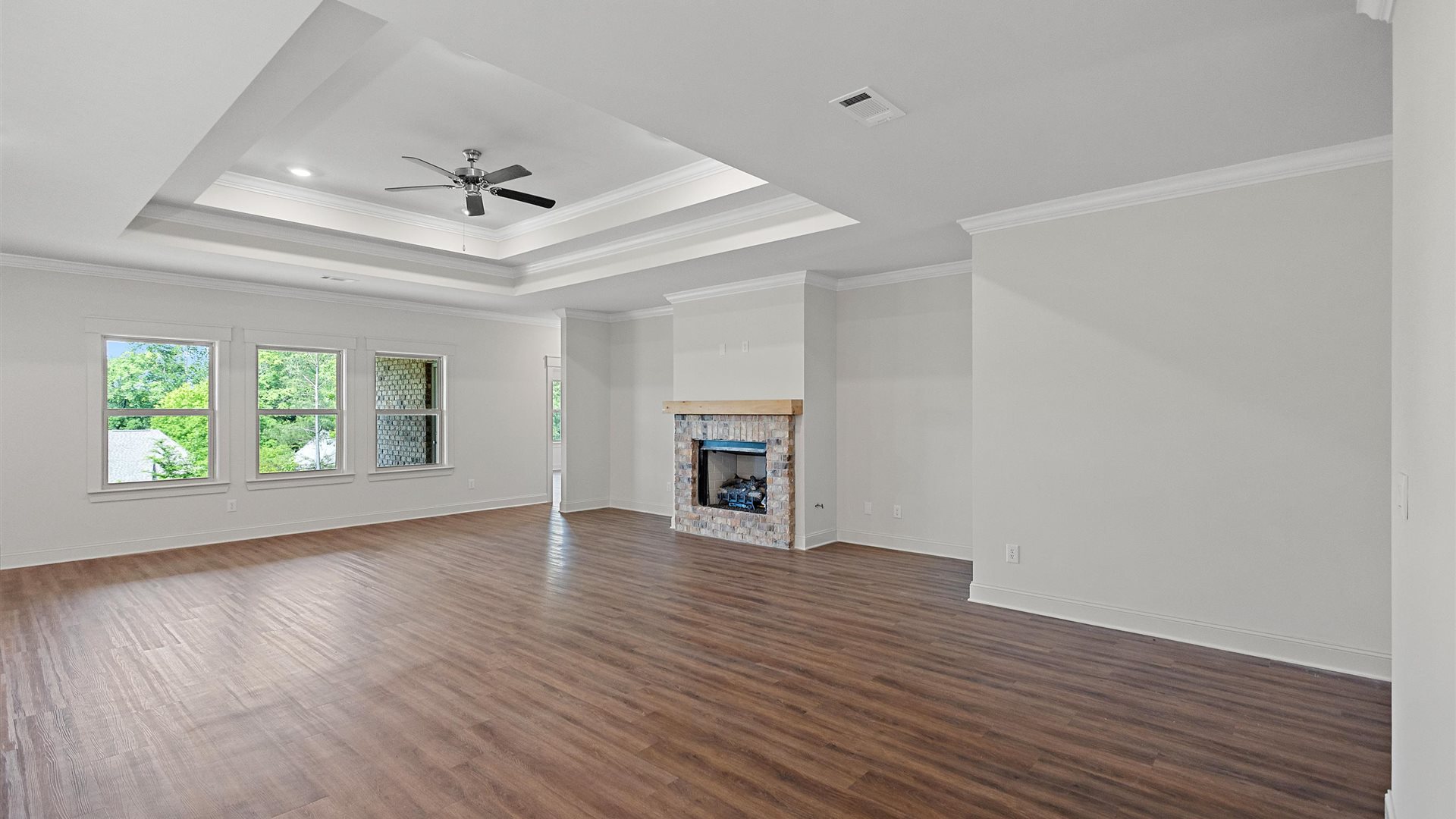 gorgeous spacious living area with a brick fireplace