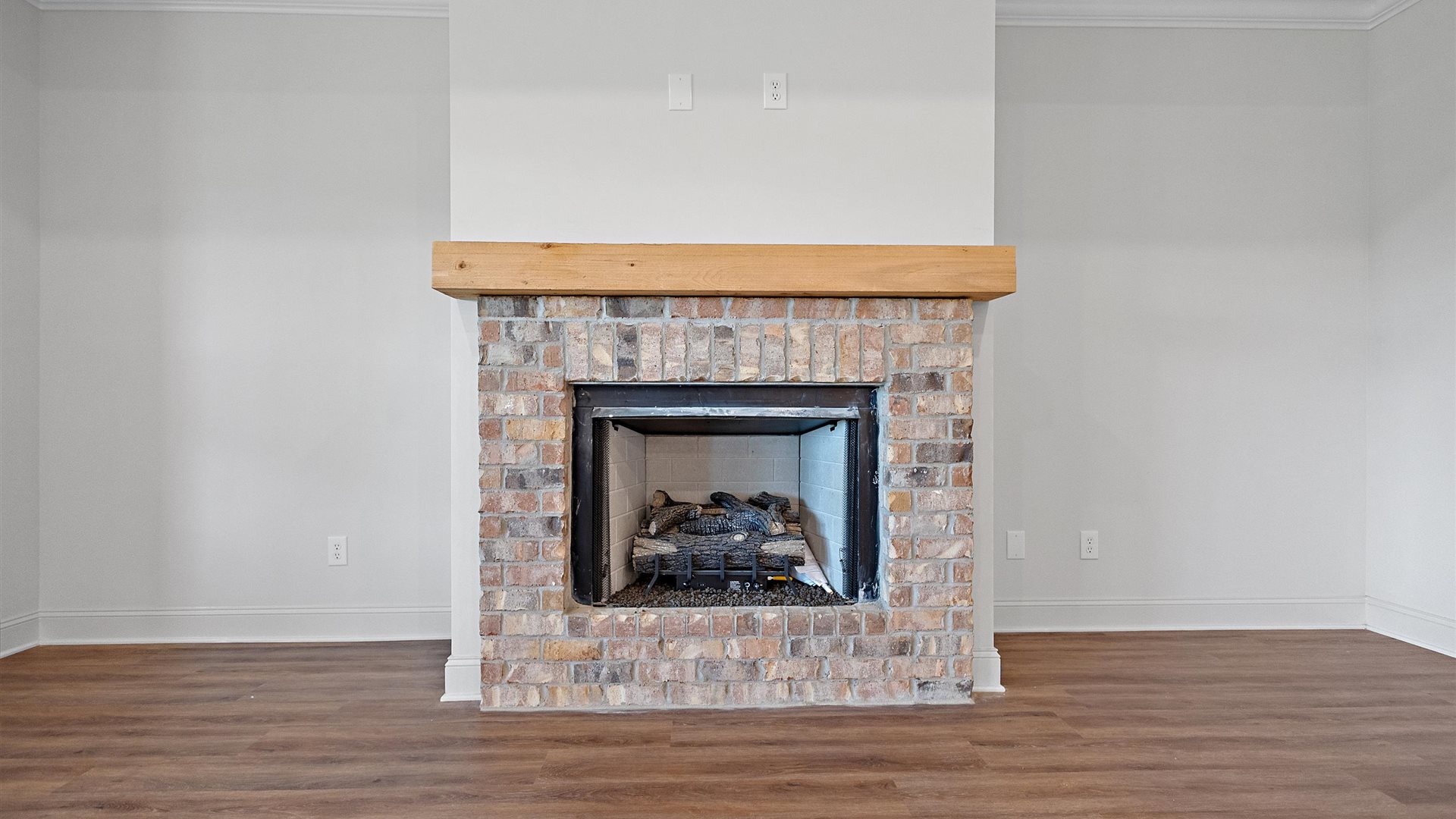 gorgeous spacious living area with a brick fireplace