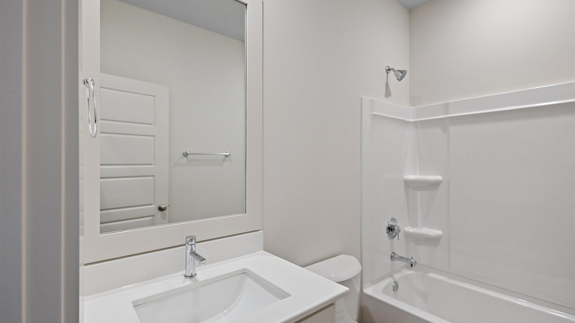 bathroom featuring a vanity sink with white cabinetry and a mirror above