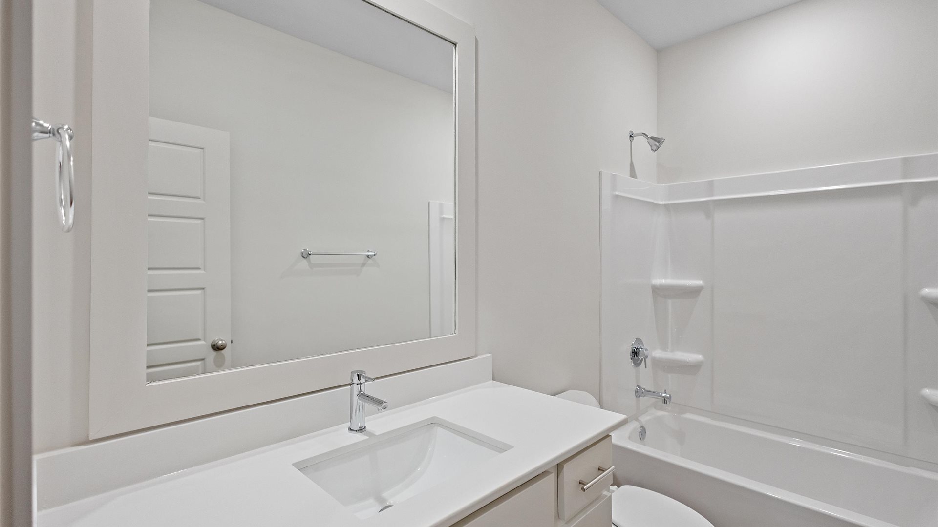 bathroom featuring a vanity sink with white cabinetry and a mirror above
