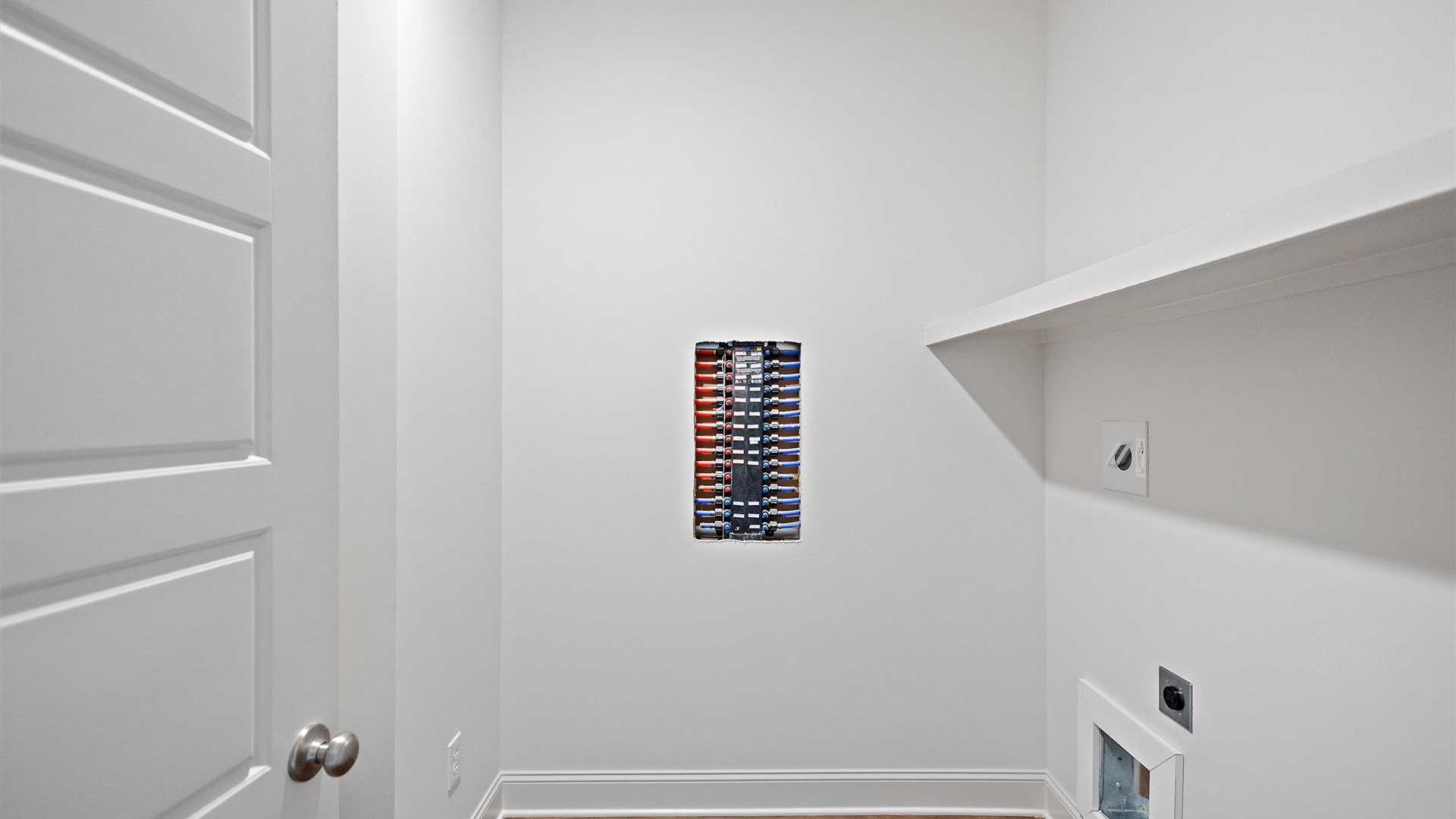 spacious laundry room with built in shelves