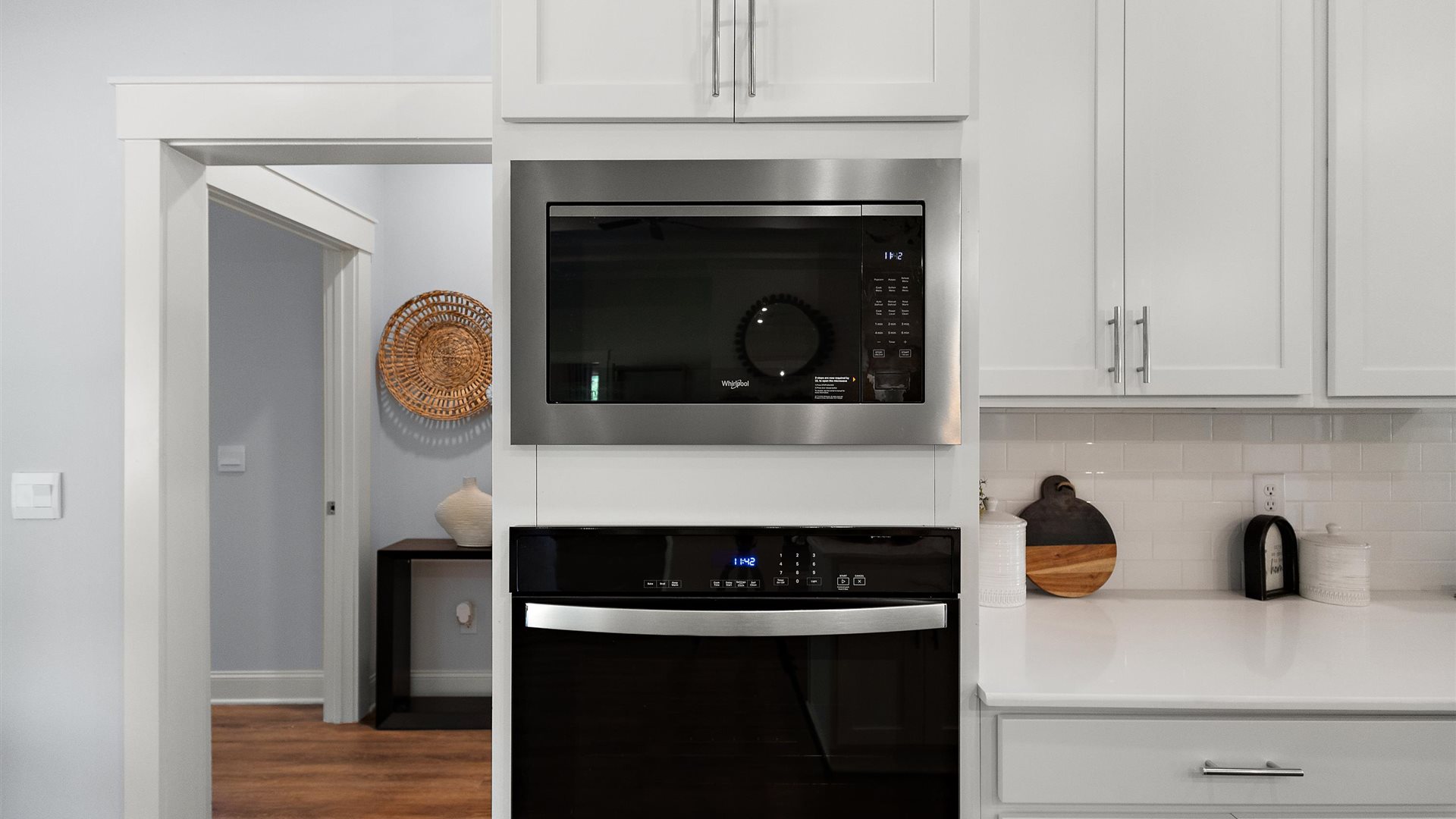 Interior kitchen with steel appliances and white cabinets