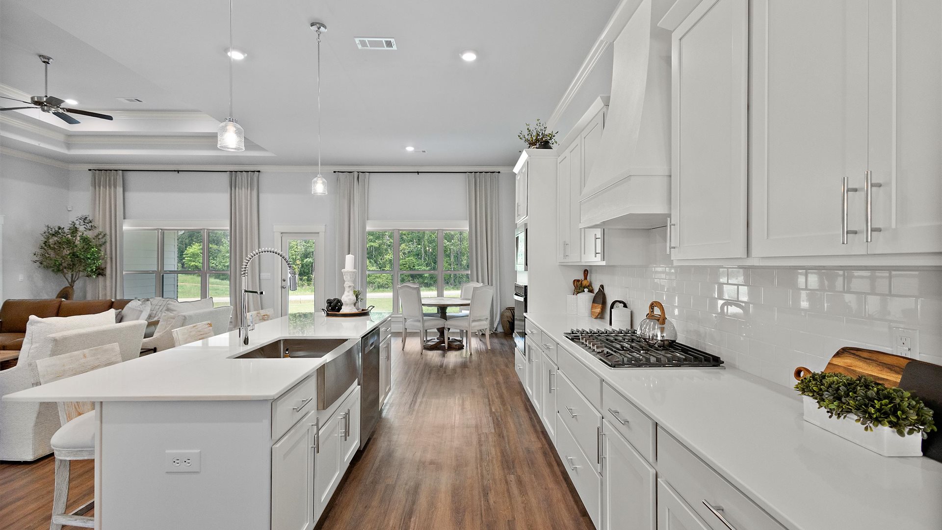 Interior kitchen with center island and white cabinets