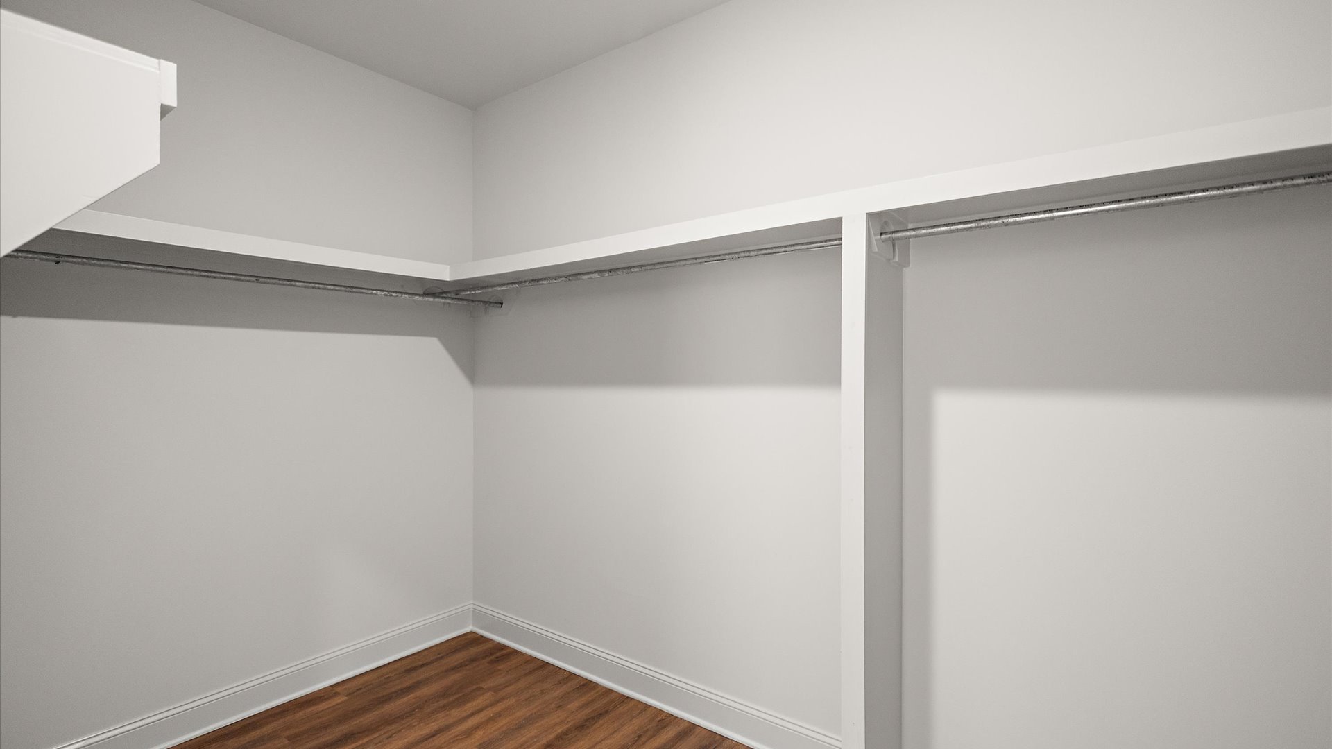 interior walk in closet with some built in shelving