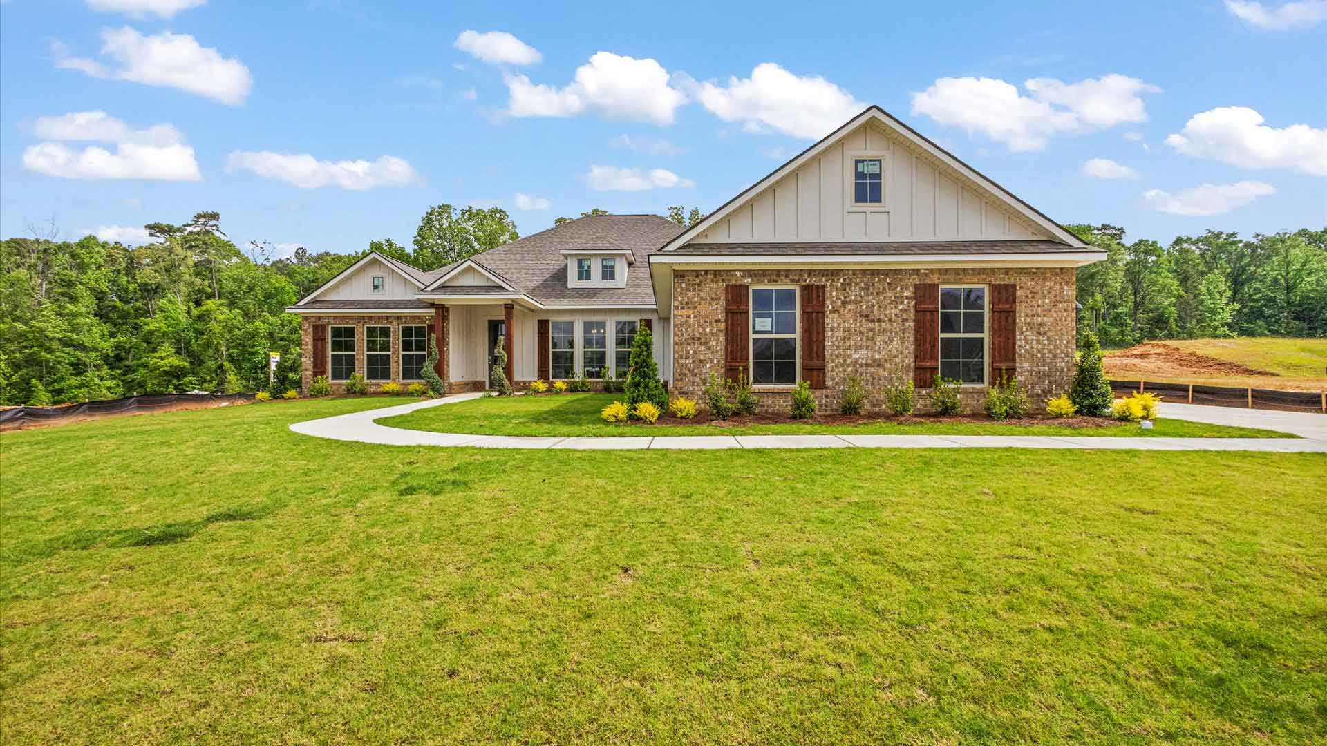 Exterior of one story home with brick siding