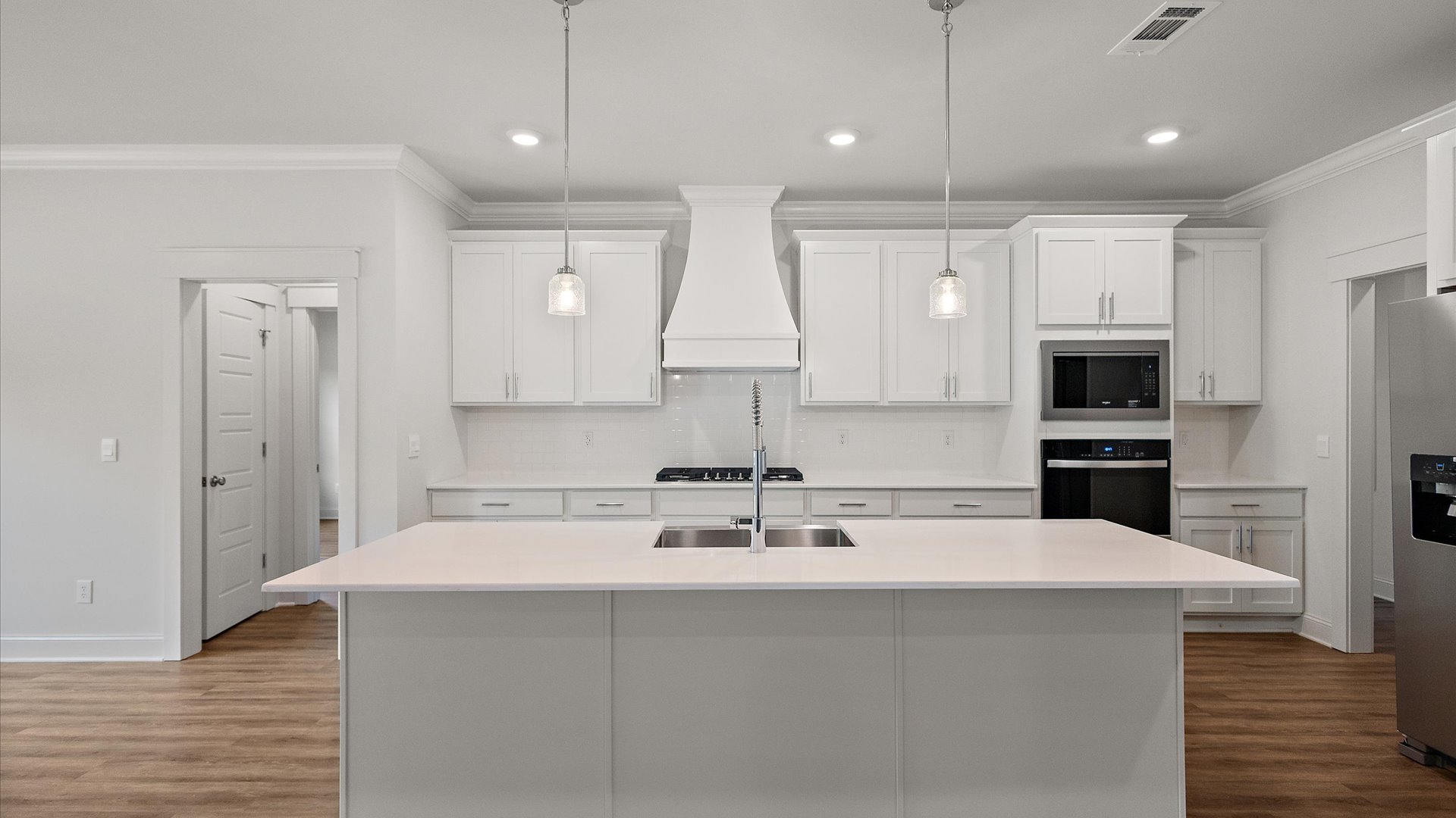 interior kitchen with white cabinets and central island
