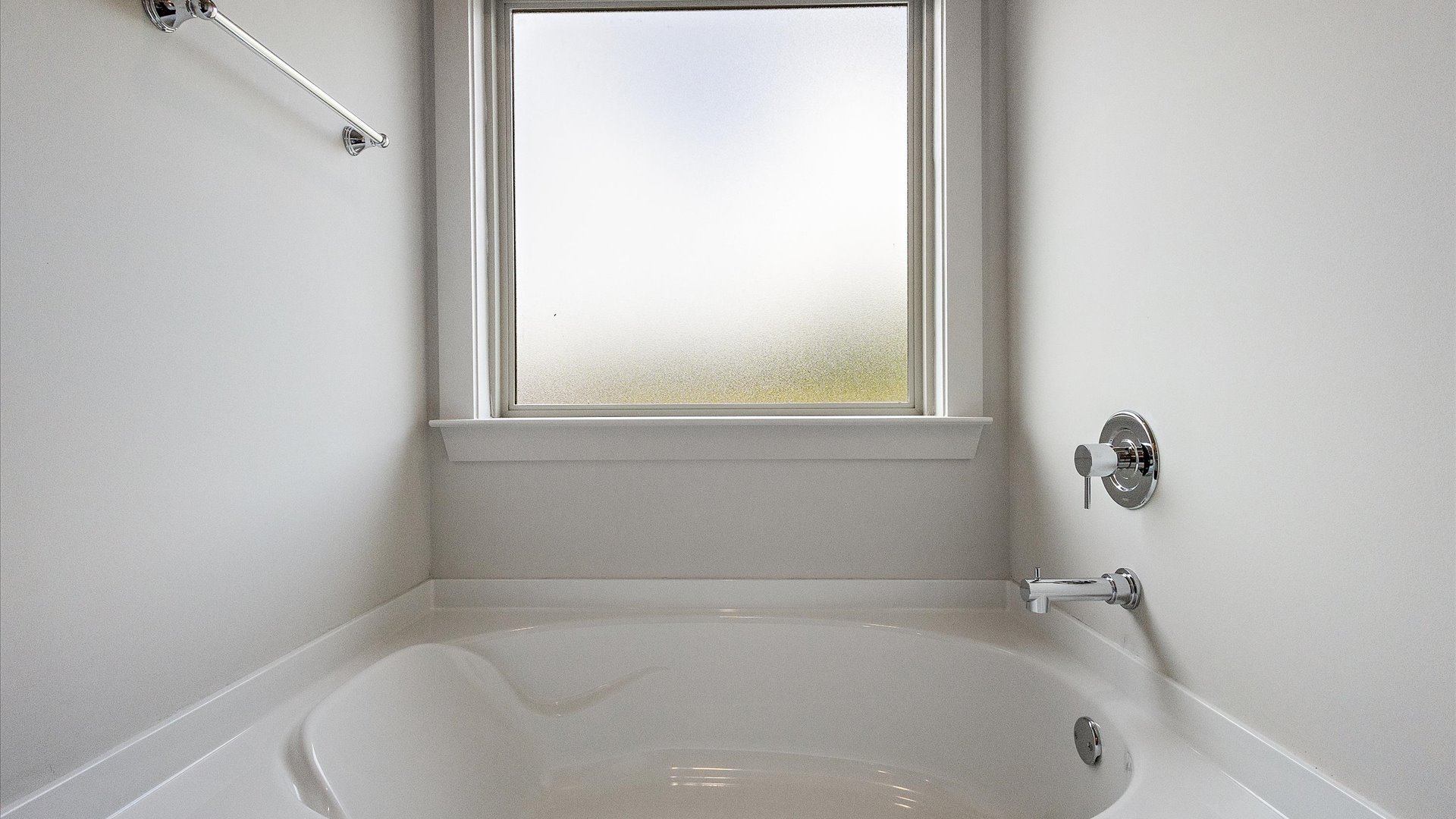 interior bathroom with bathtub and big frosted window
