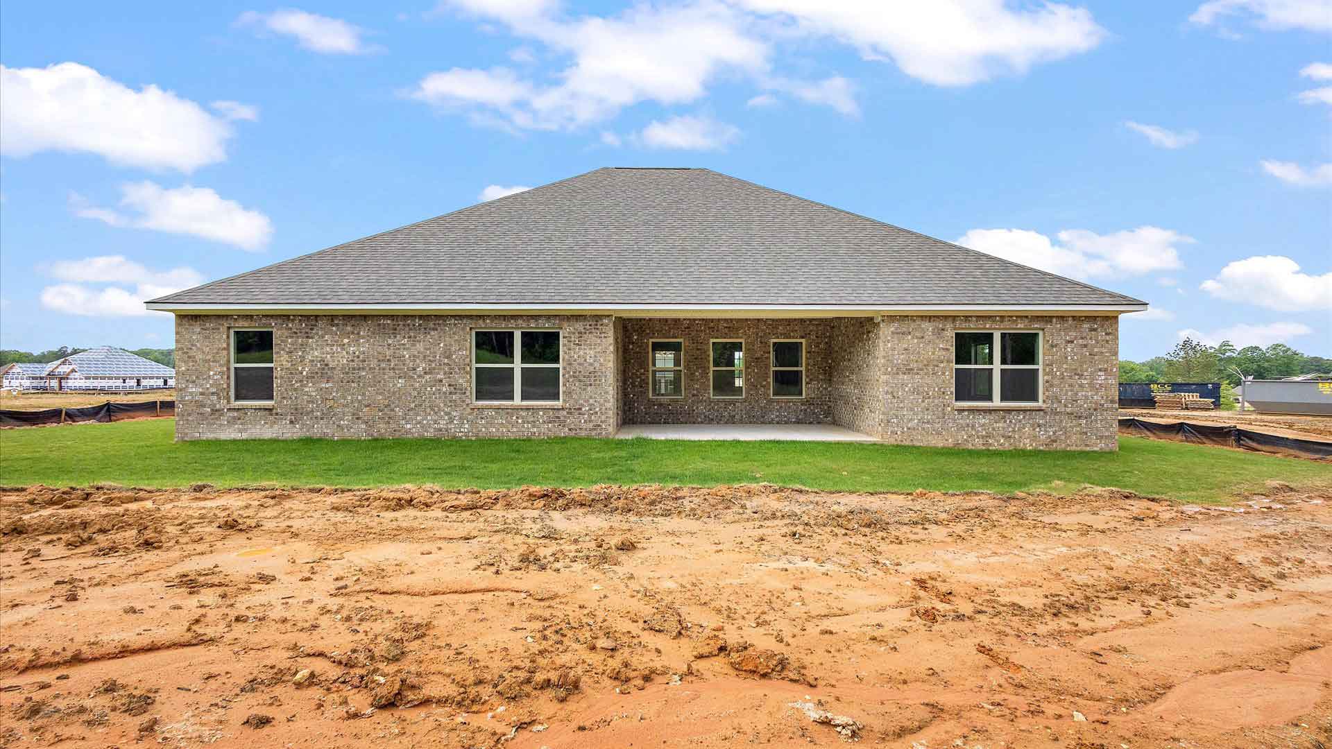 exterior of one story brick home and back porch