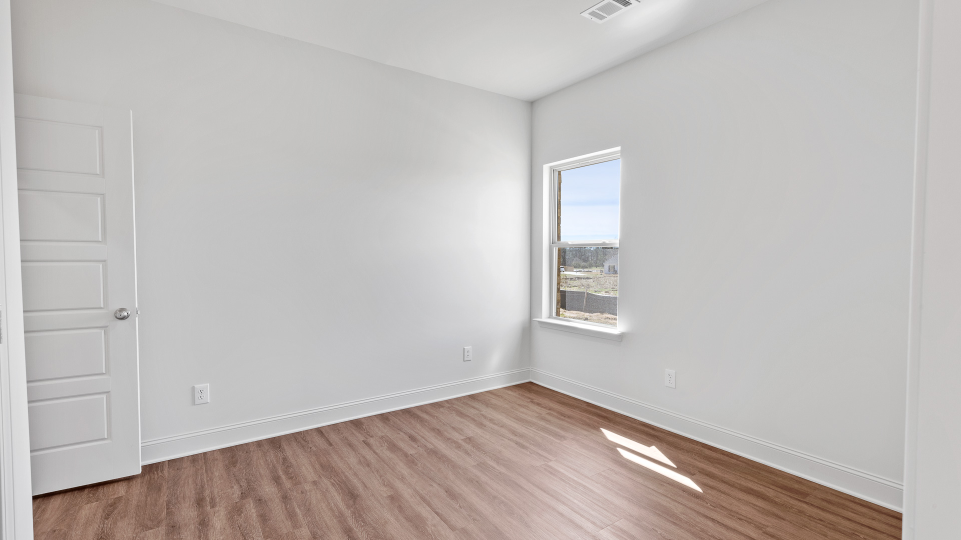 bedroom with hardwood flooring and window