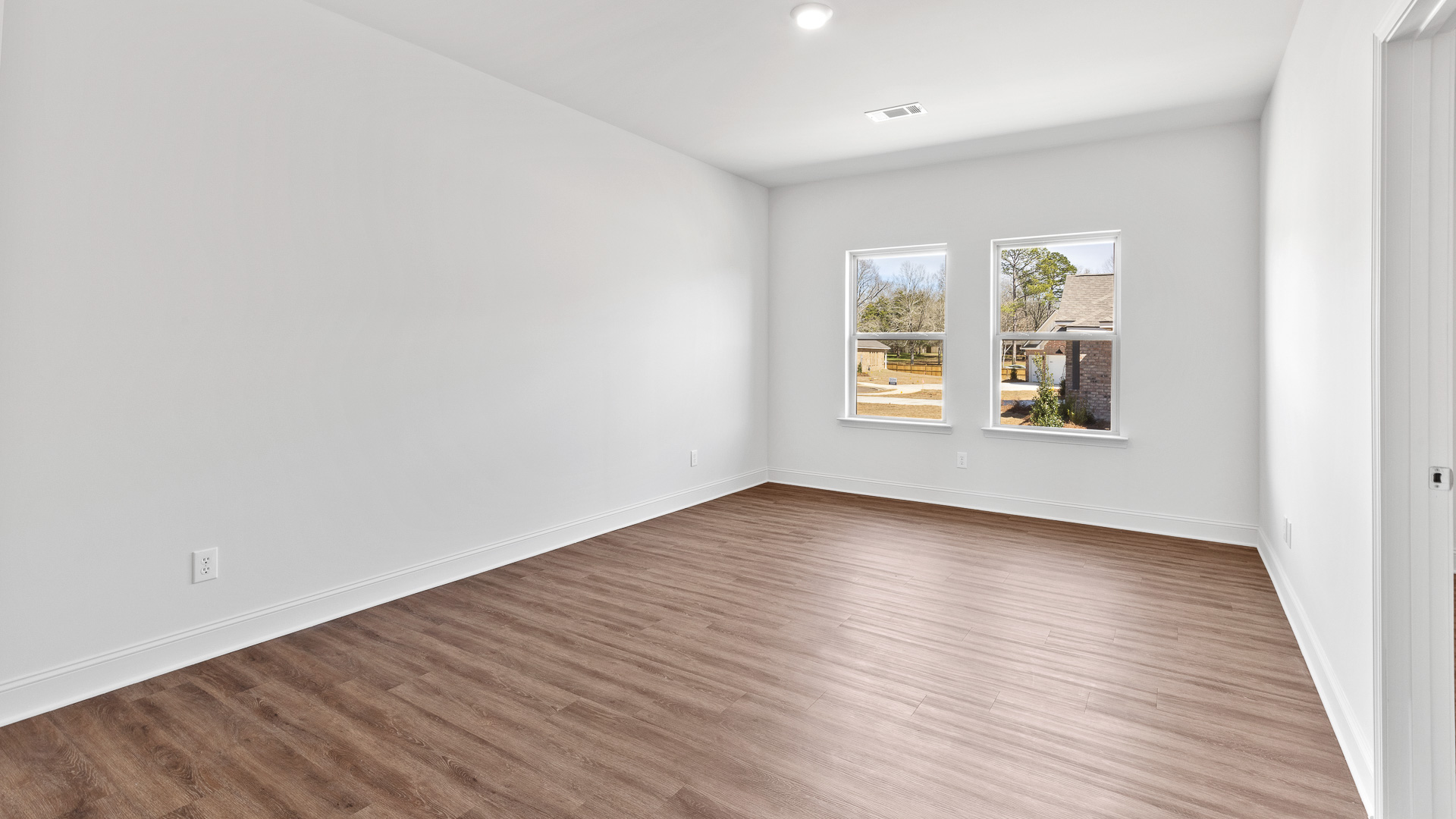 additional bedroom with hardwood flooring