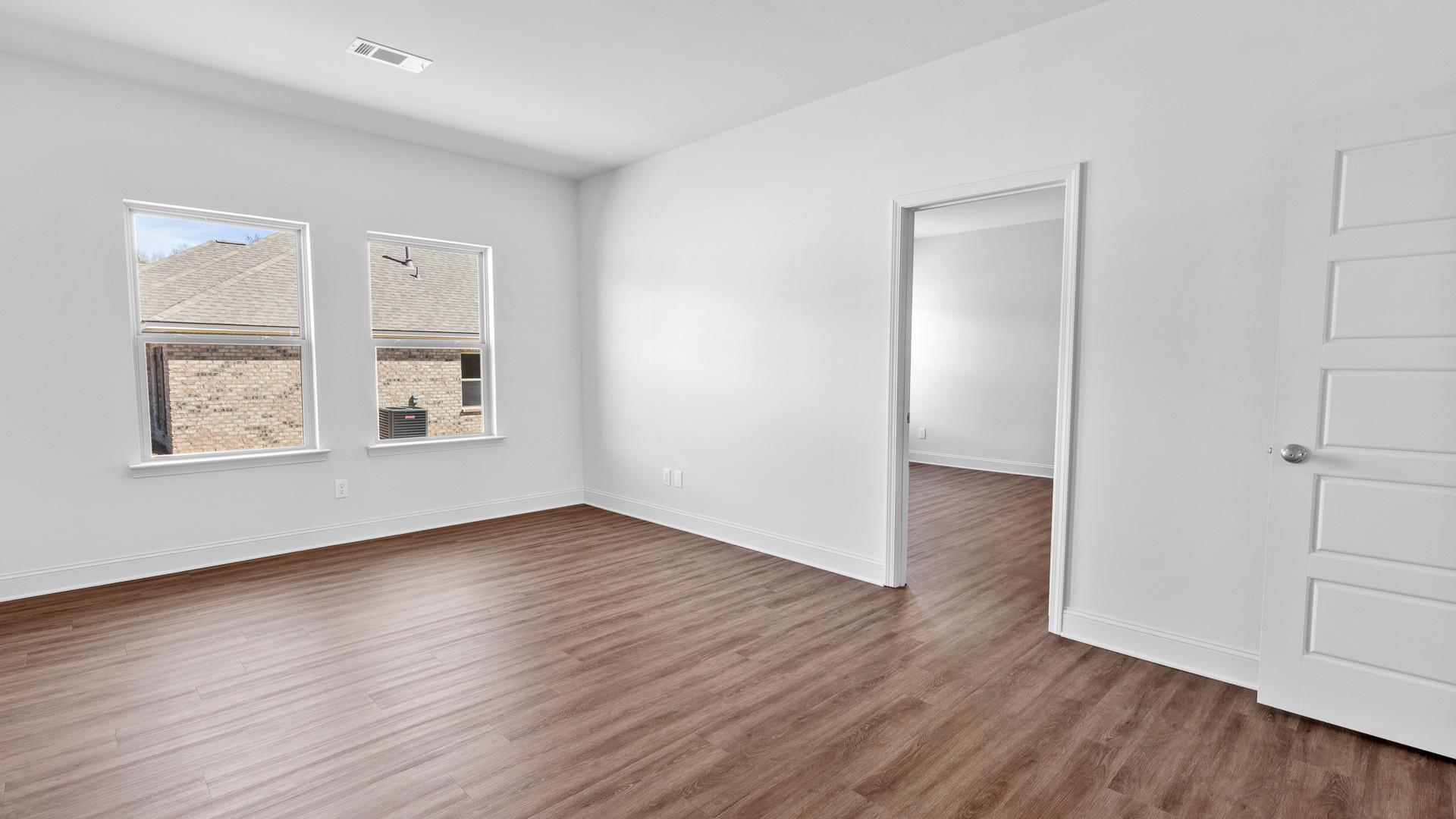 additional bedroom with hardwood flooring