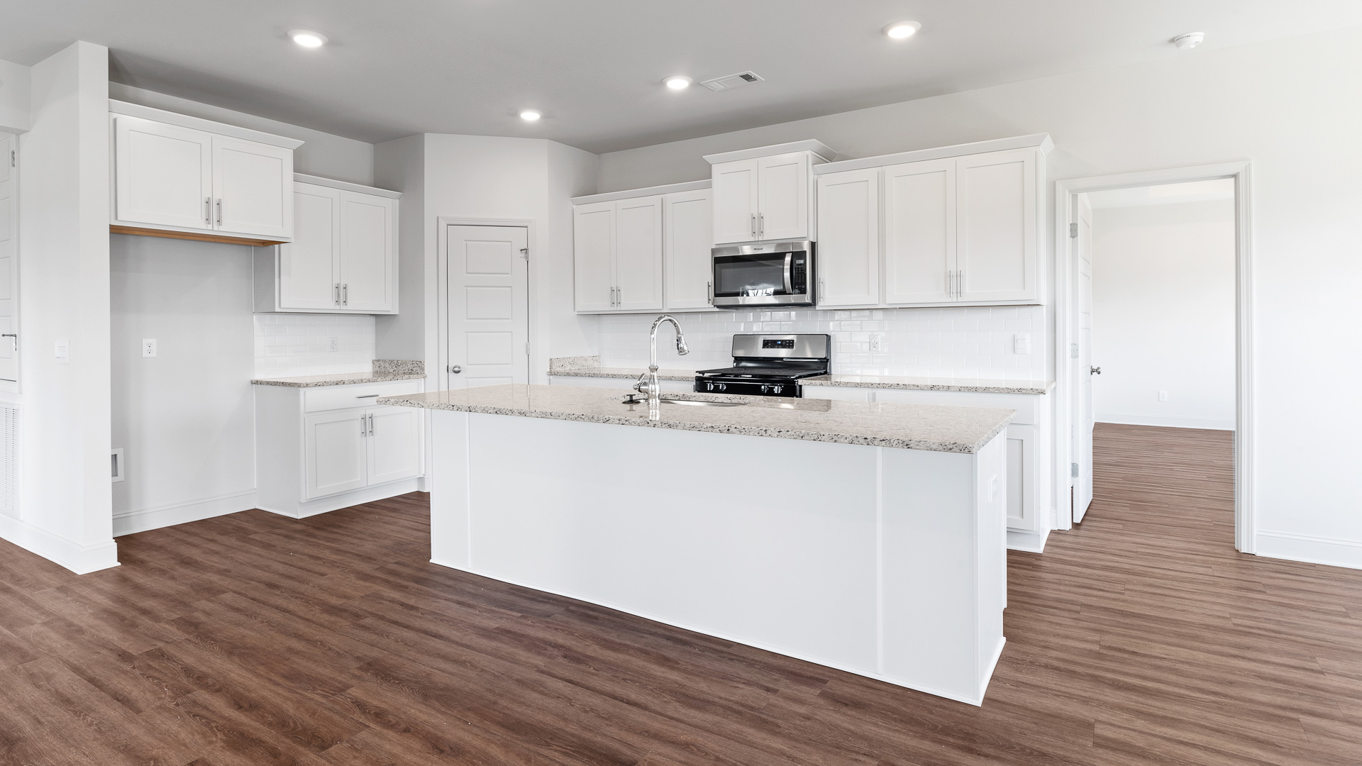 modern kitchen with granite countertops, recessed lighting, stainless steel appliances, and shaker cabinets