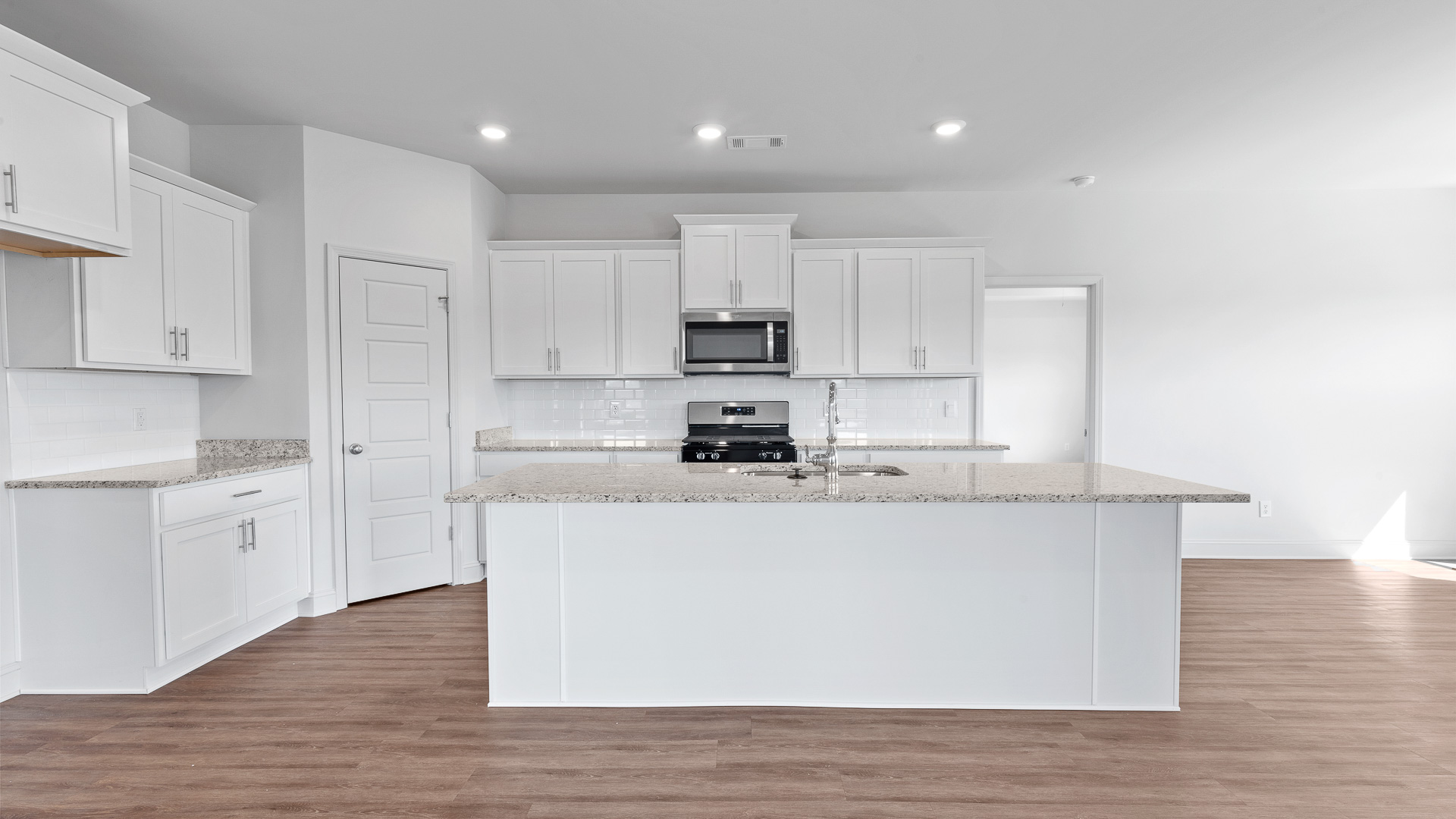 modern kitchen with granite countertops, recessed lighting, stainless steel appliances, and shaker cabinets