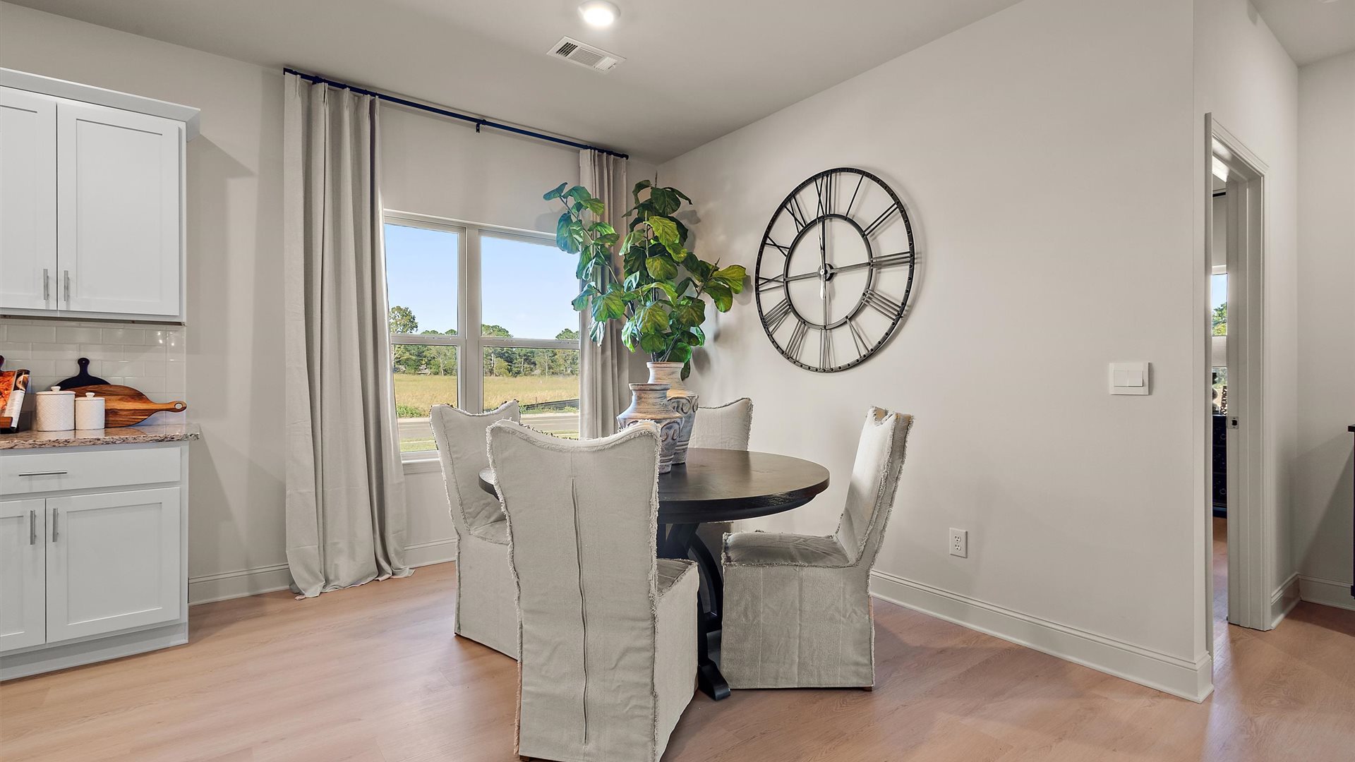 Breakfast nook area with hardwood floors, window, and recessed lighting.