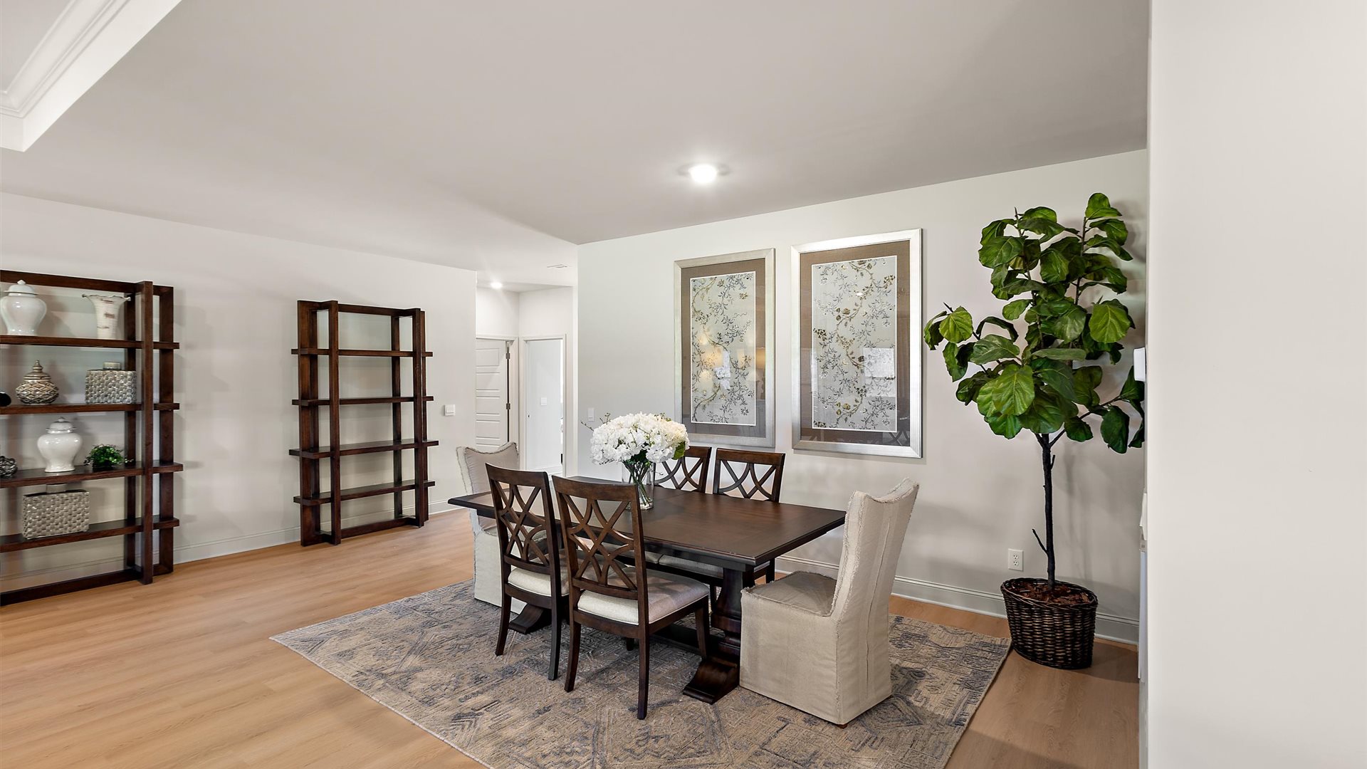 Dining area with hardwood floors and recessed lighting.