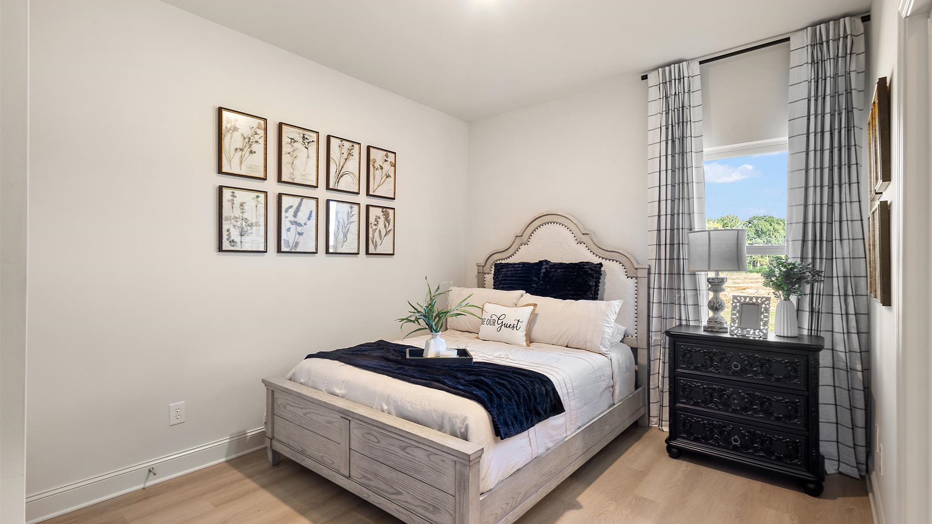 Additional bedroom with window and hardwood floors