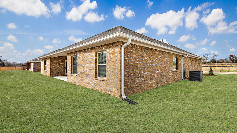 The covered patio opens to greenspace.